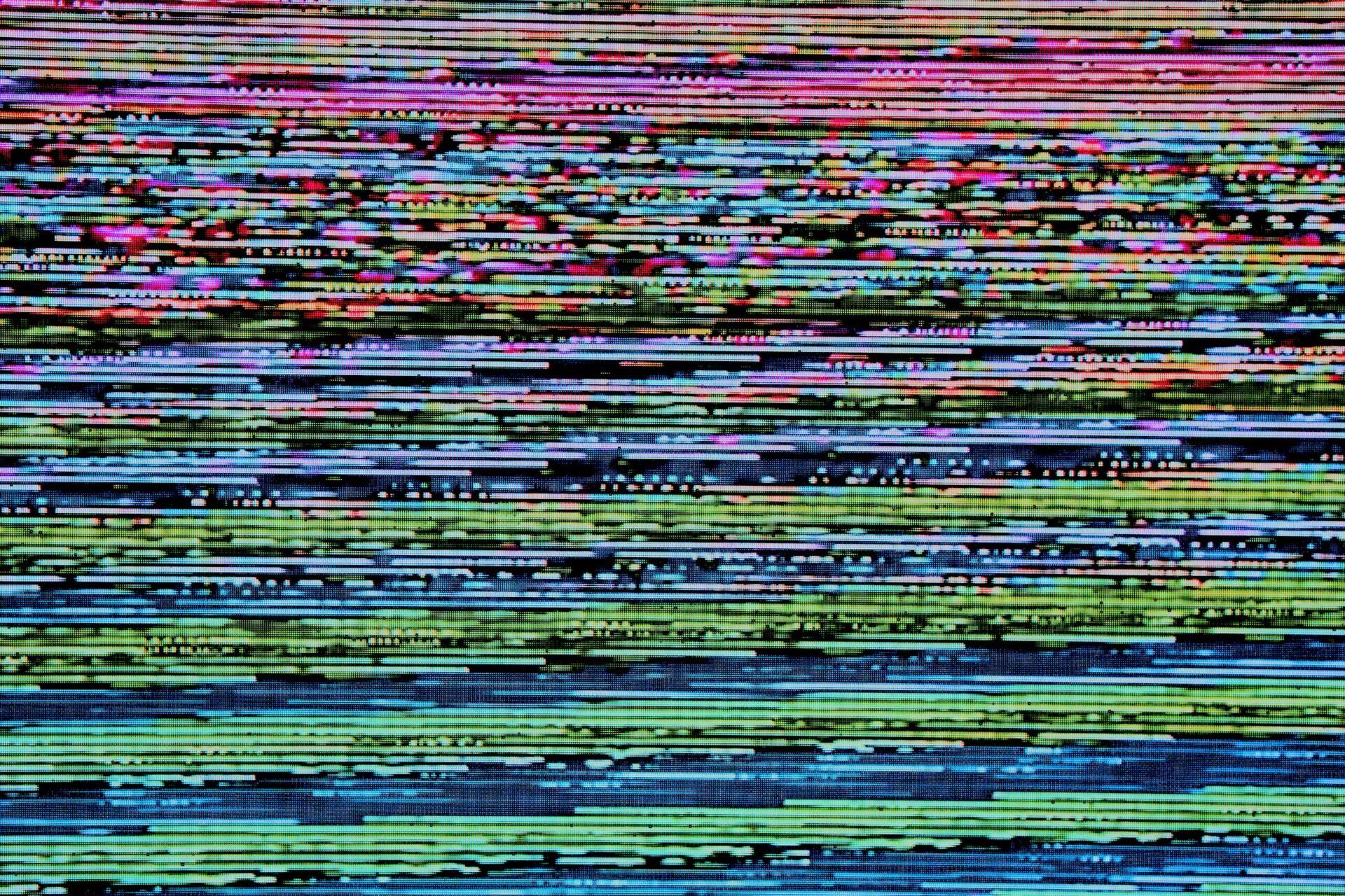 Computer display showing horizontal coloured glitch lines and distorted visual patterns across the screen.