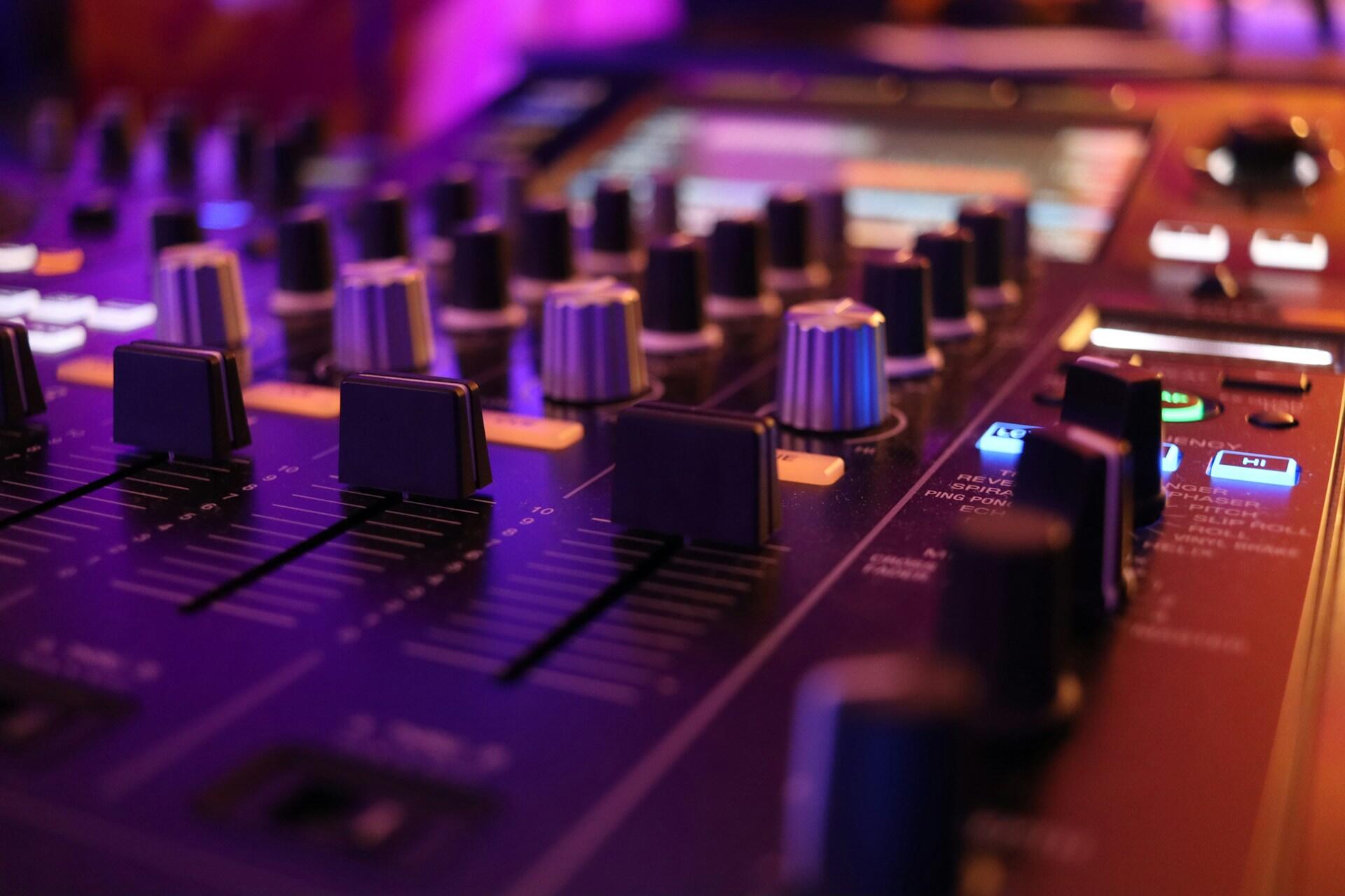 Close-up of a professional audio mixing console used in music production and sound engineering.