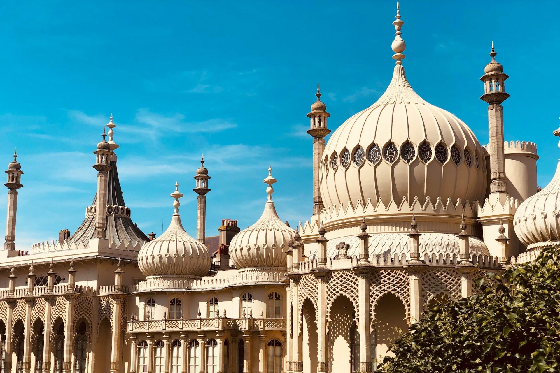 Brighton Royal Pavilion building with domes and towers under a blue sky