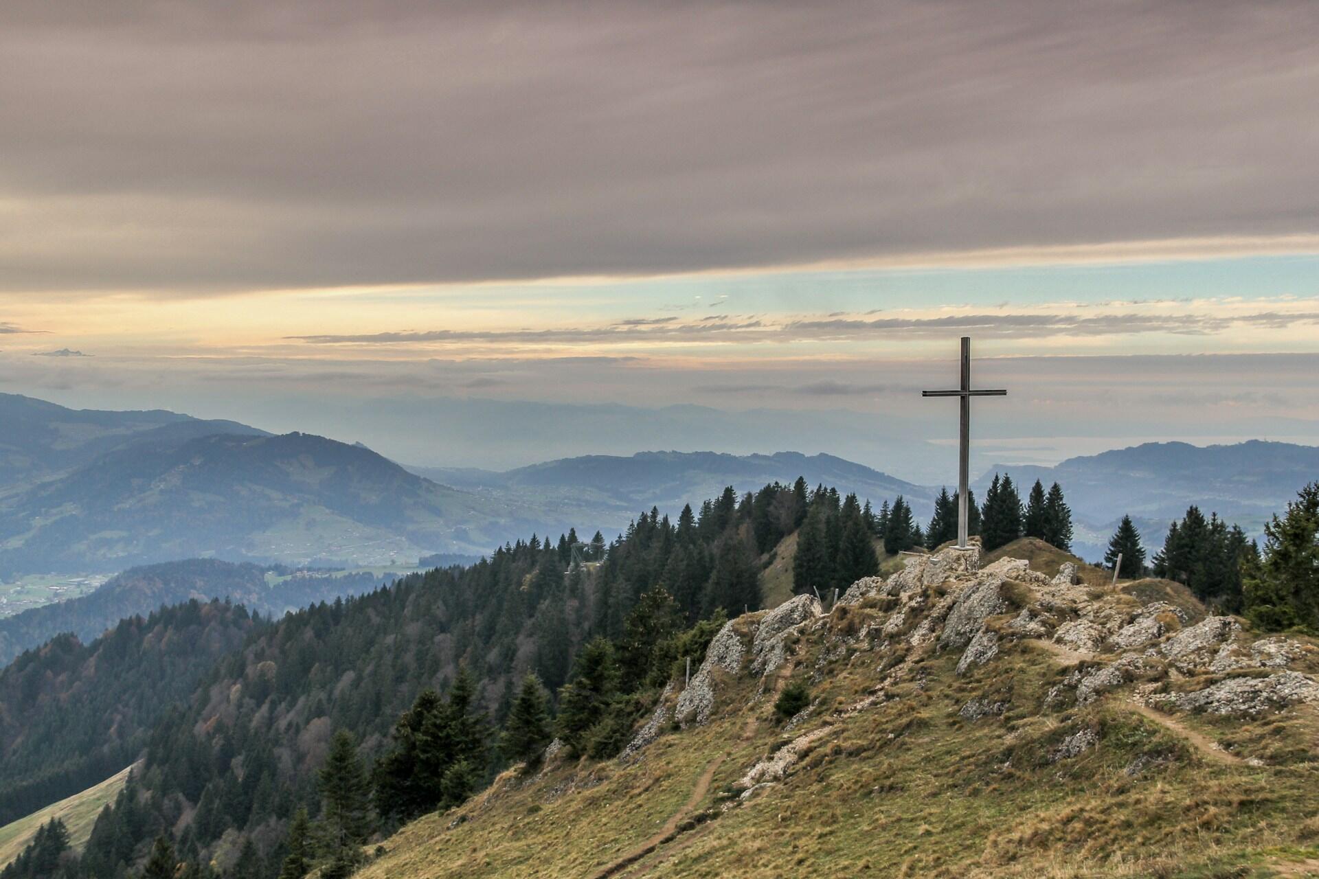 landscape of a mountain with a cross sitting at the top