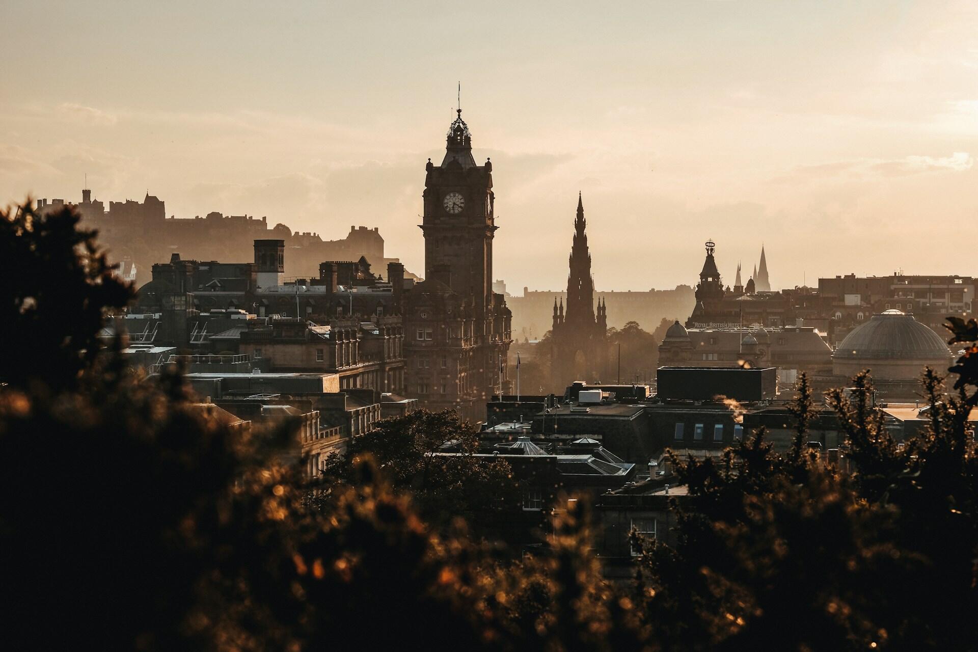 Edinburgh skyline with clock tower and Scott Monument at sunset