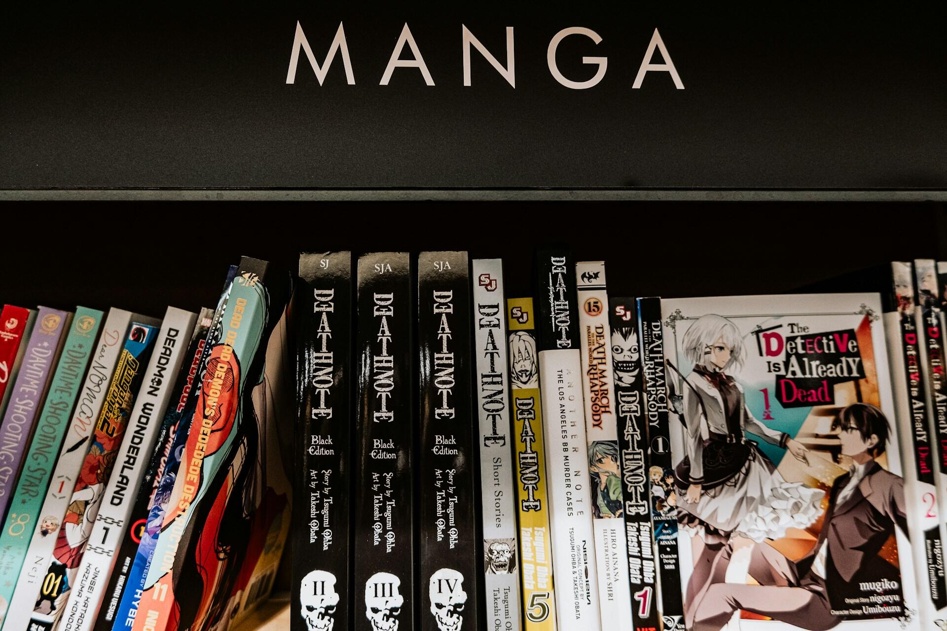 Shelf labeled "MANGA" filled with various manga volumes, prominently featuring multiple editions of "Death Note" and other titles.