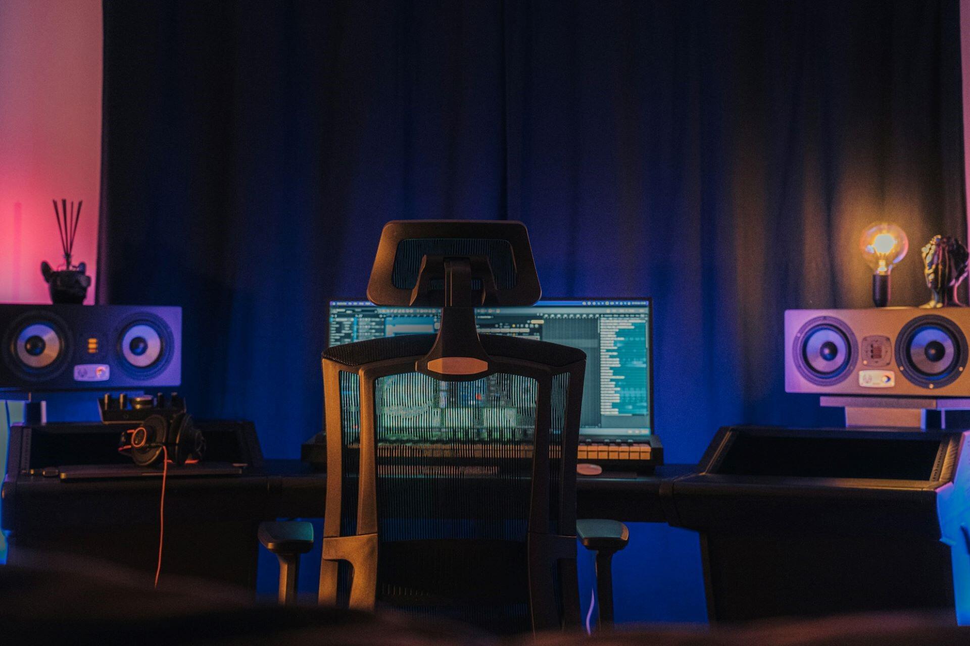 Modern music production workstation with studio monitors and computer screen