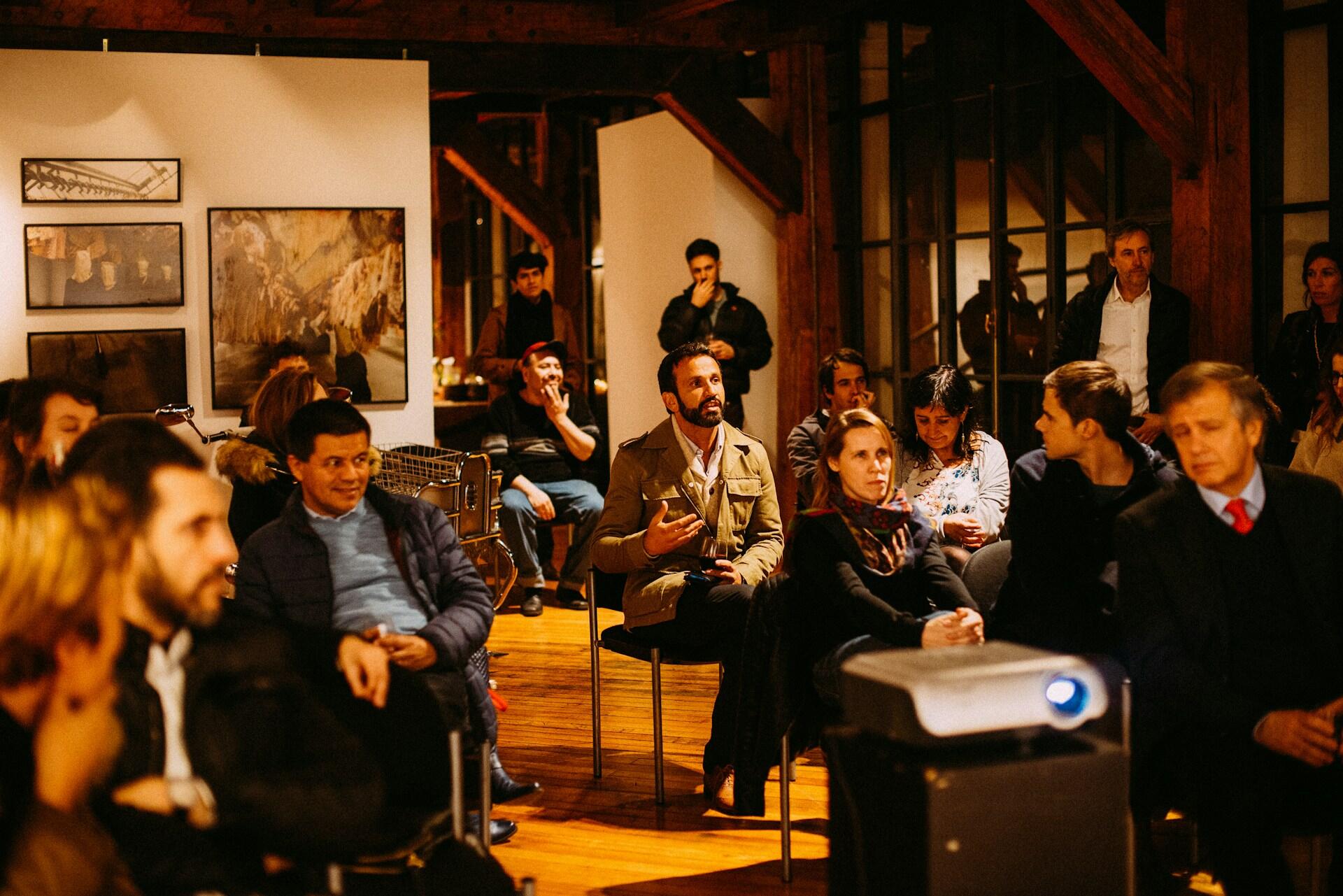 A group of people seated in an informal arrangement in a town council meeting. 