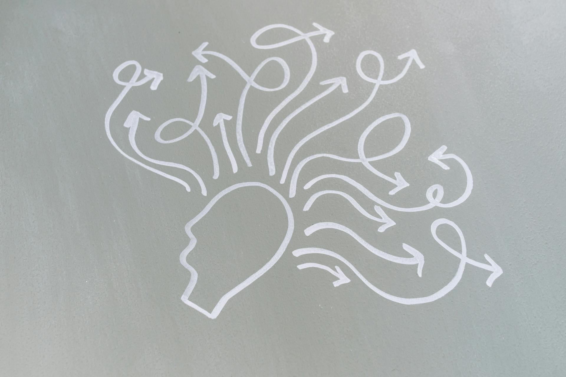 Dawn image of a head with arrows representing different paths of thinking