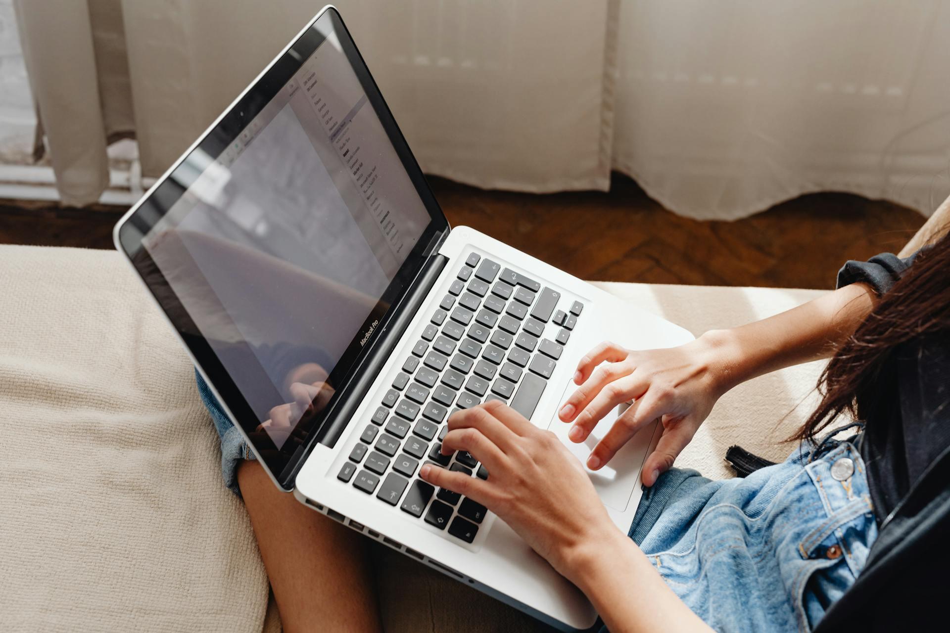 Lady typing on computer on her lap