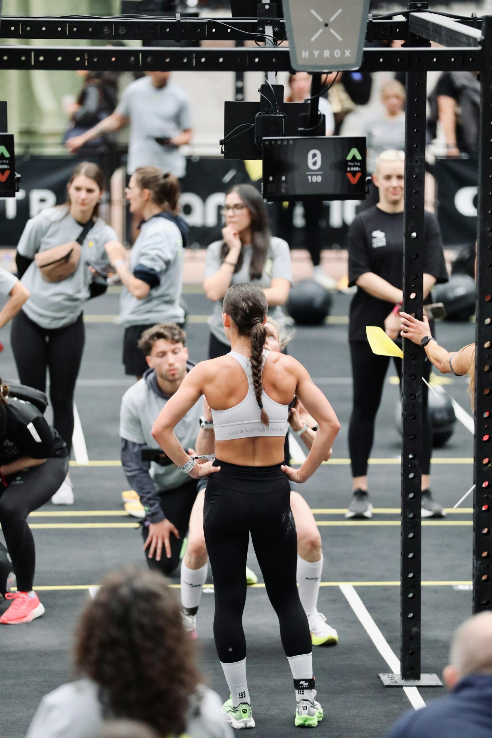 A group of people wearing sports clothing stand on a competition floor. 