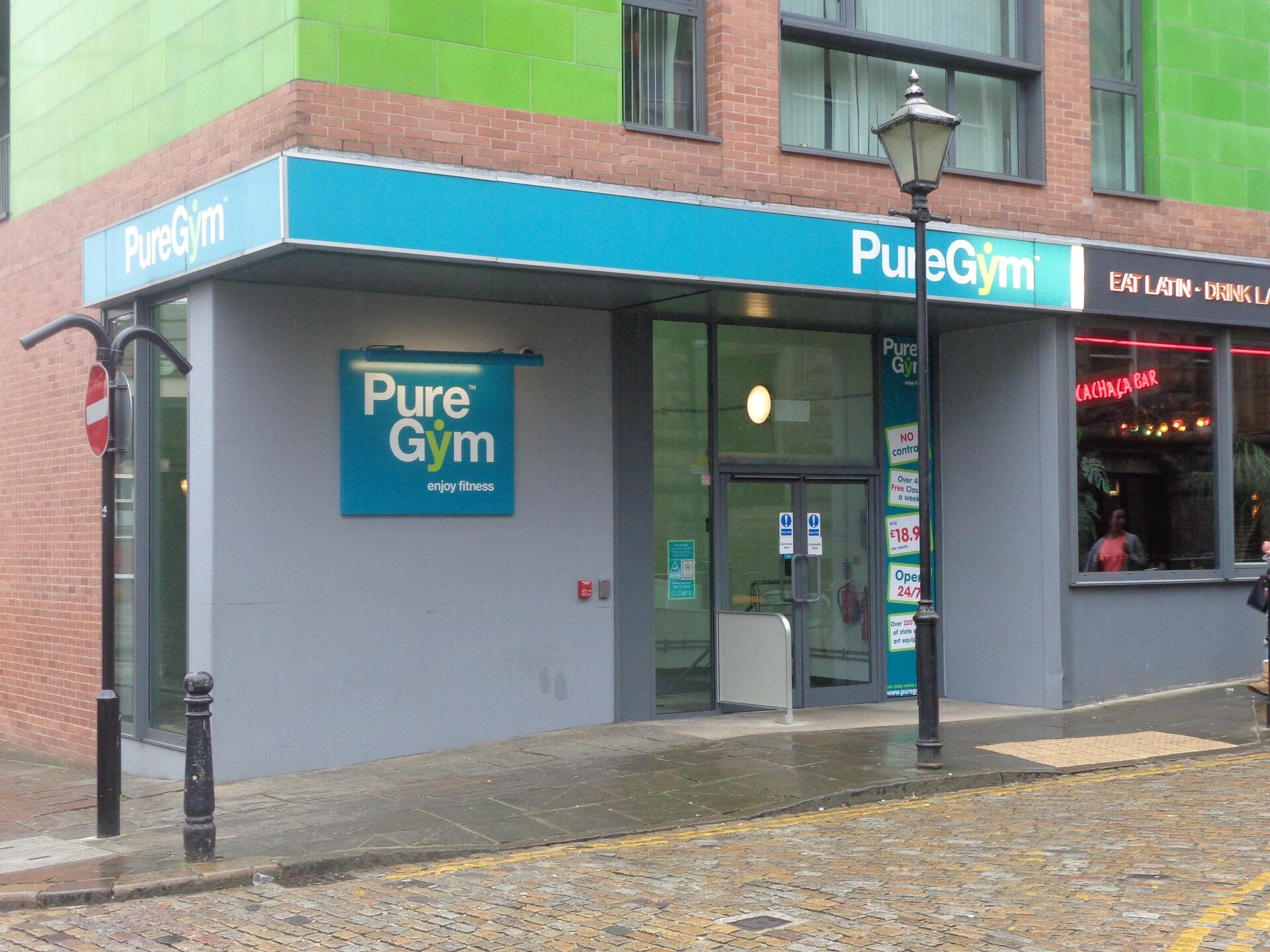 The entrance to a PureGym facility, marked by a simple blue and white sign. 