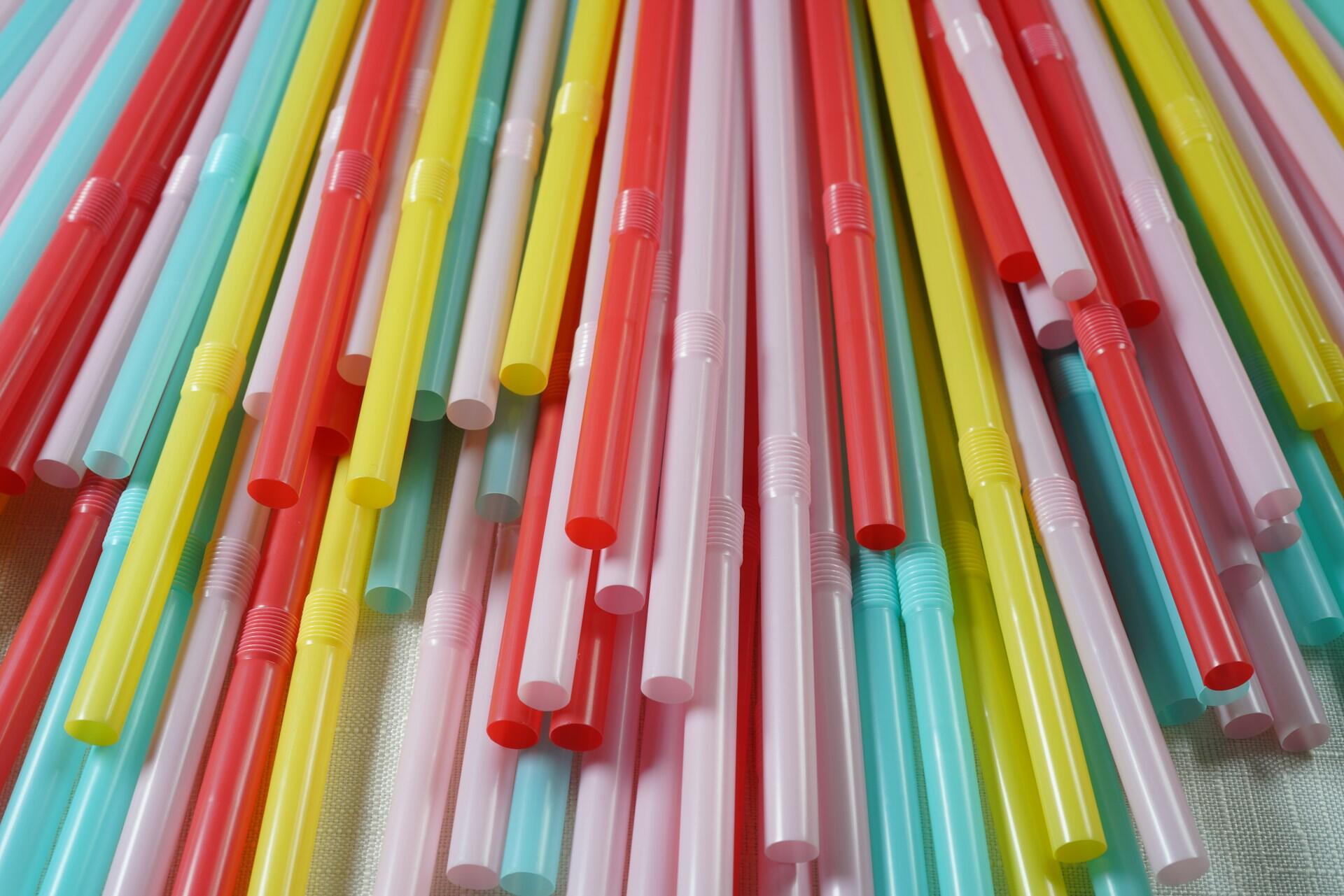 Colourful plastic straws used for straw phonation vocal warm-up exercises.