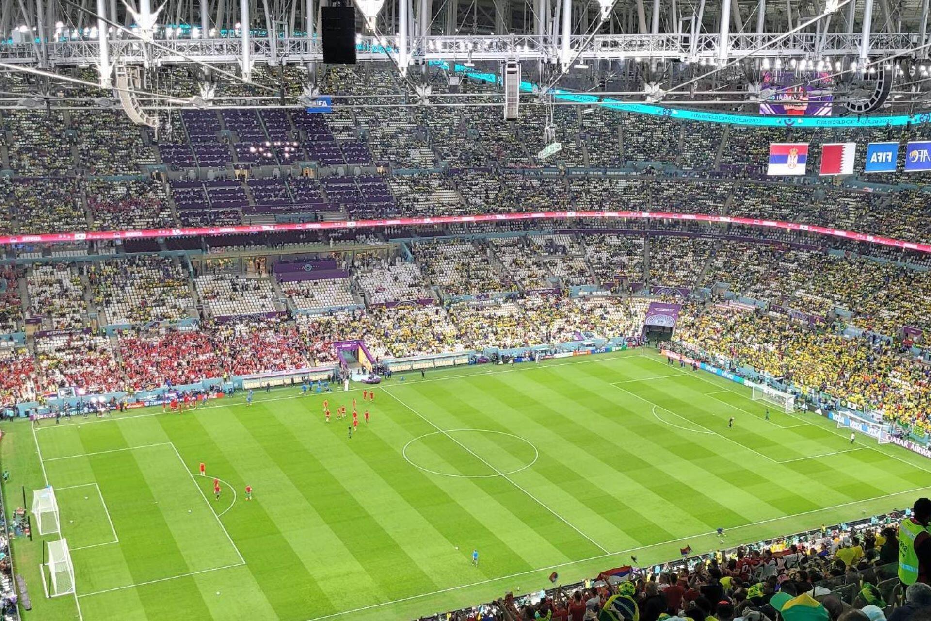 A packed stadium during a FIFA World Cup football match with fans filling the stands.
