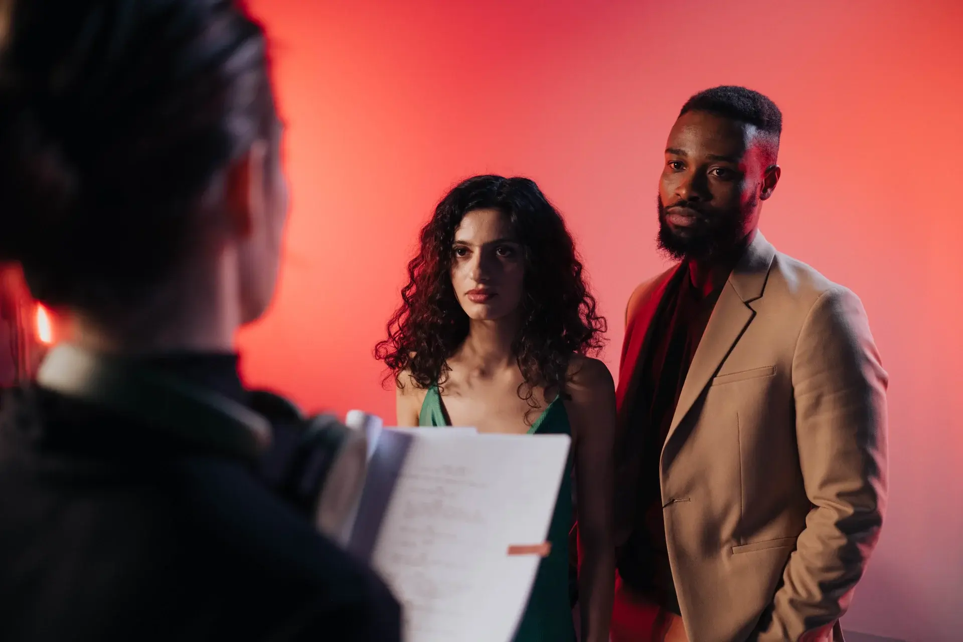 actors on stage taking direction from the director