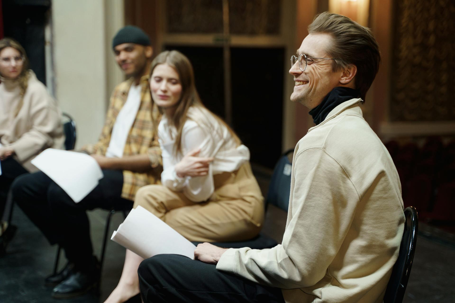 actors in a group audition reading from scripts