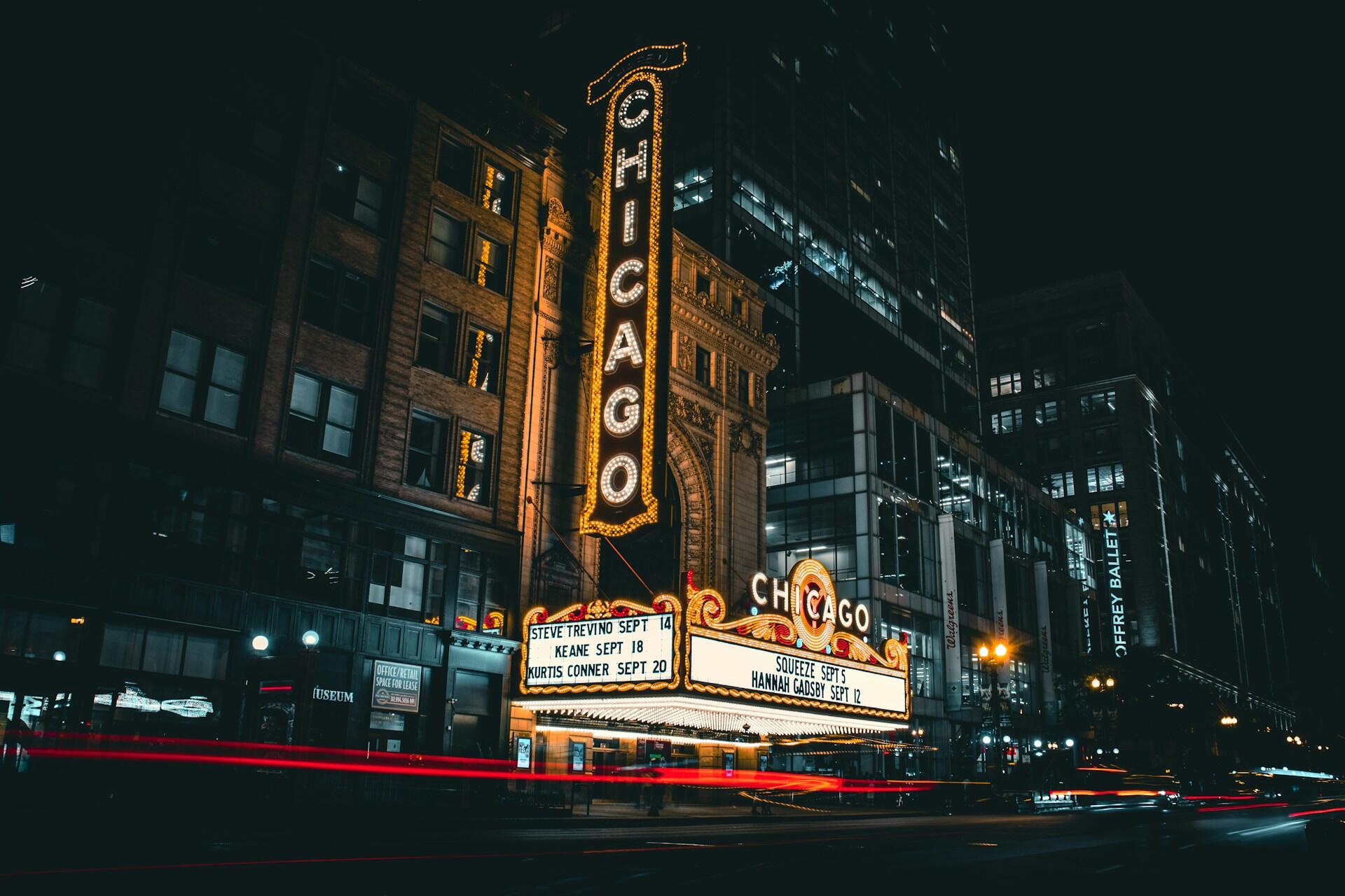 exterior of famous Chicago theatre with marquee and lights lit up
