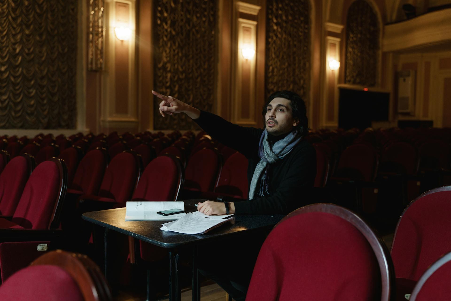 a director giving the actor auditioning on stage an instruction