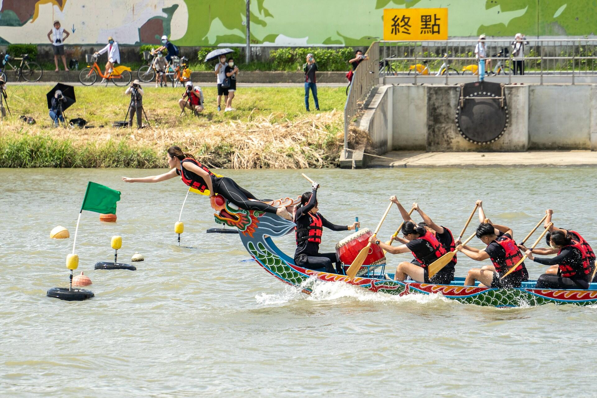 A narrow, colourful boat with a dragon at its prow and a drummer setting the pace for the rowers.