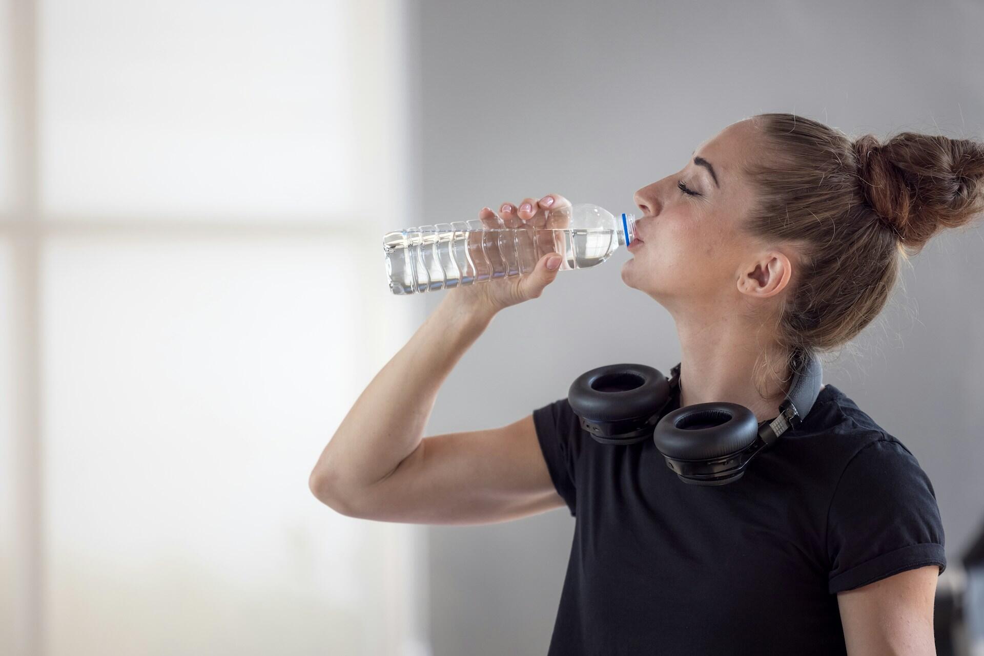 a person drinking from a water bottle