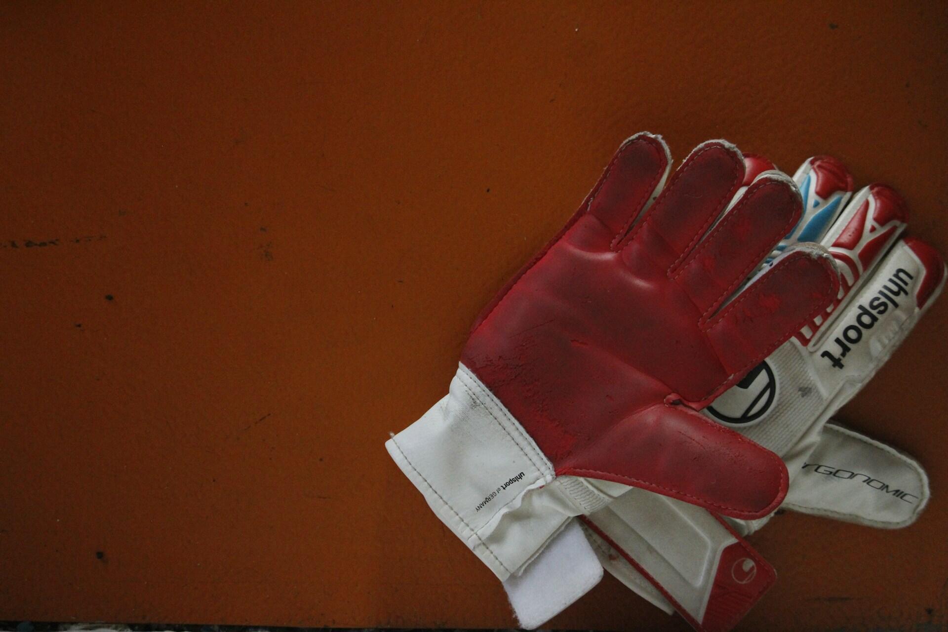 Goalkeeper gloves on a changing-room floor