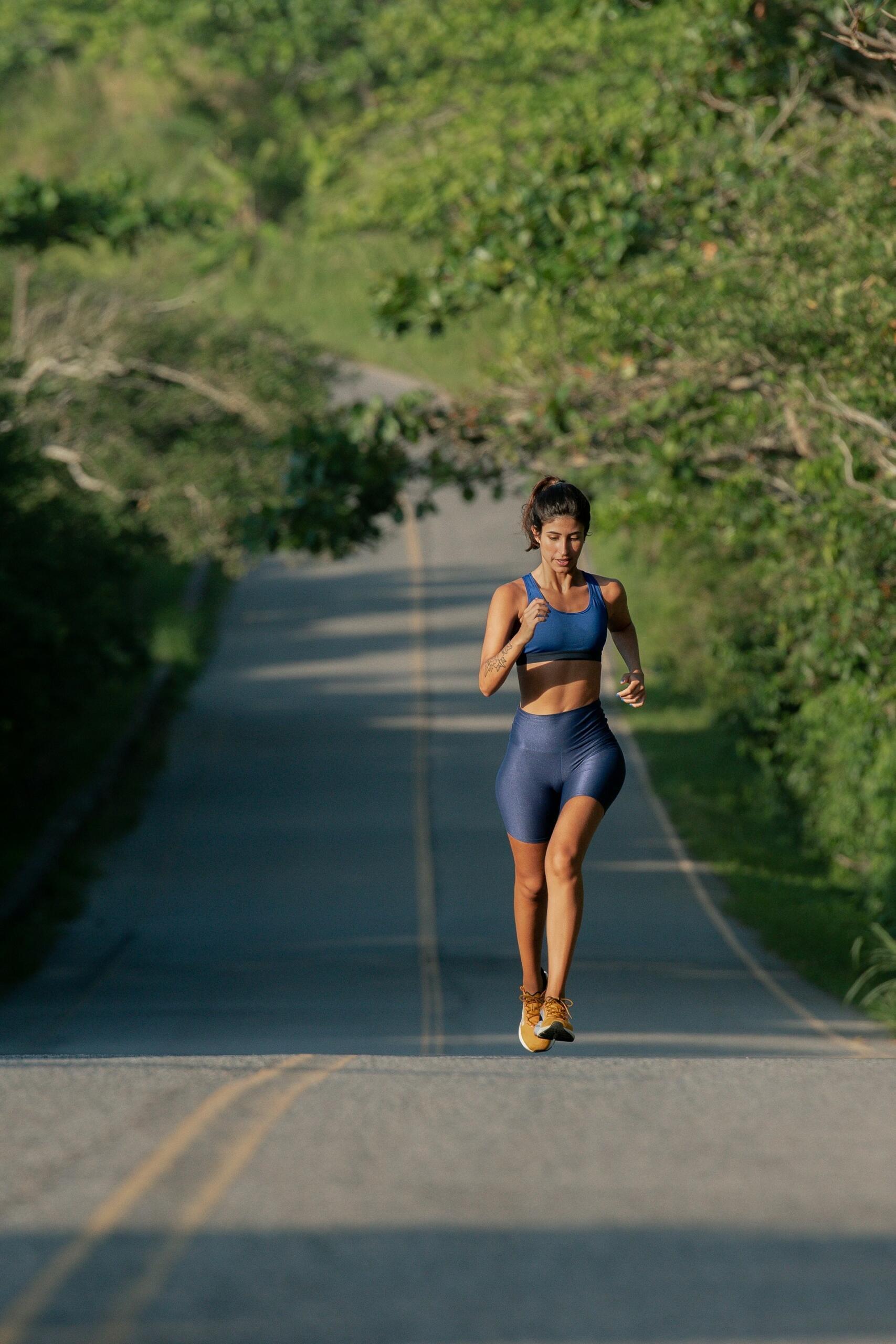 woman in sportsgear running along an outdoor path