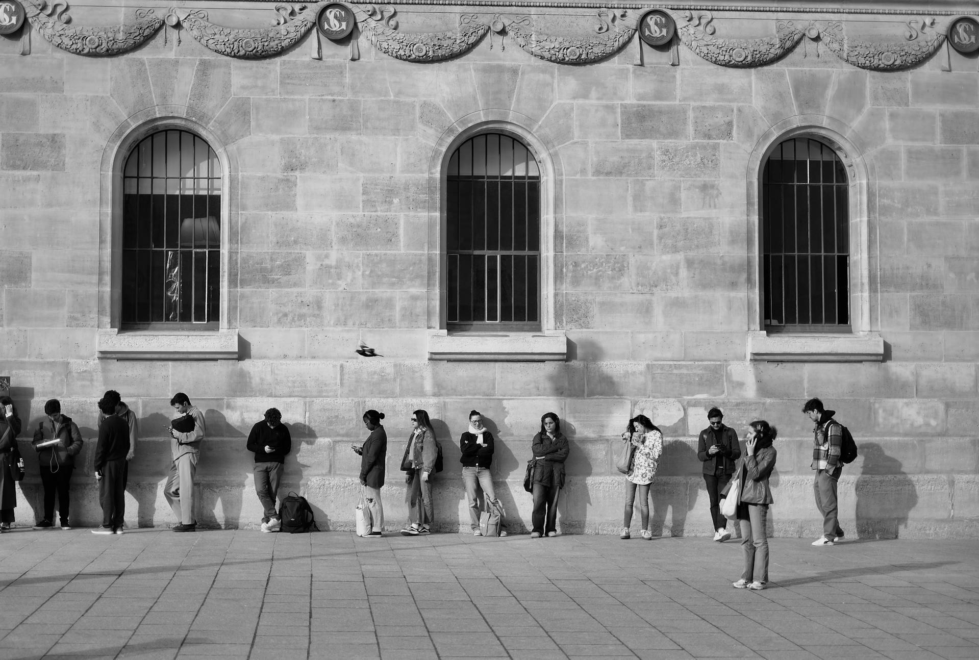 many people waiting in line outside a building