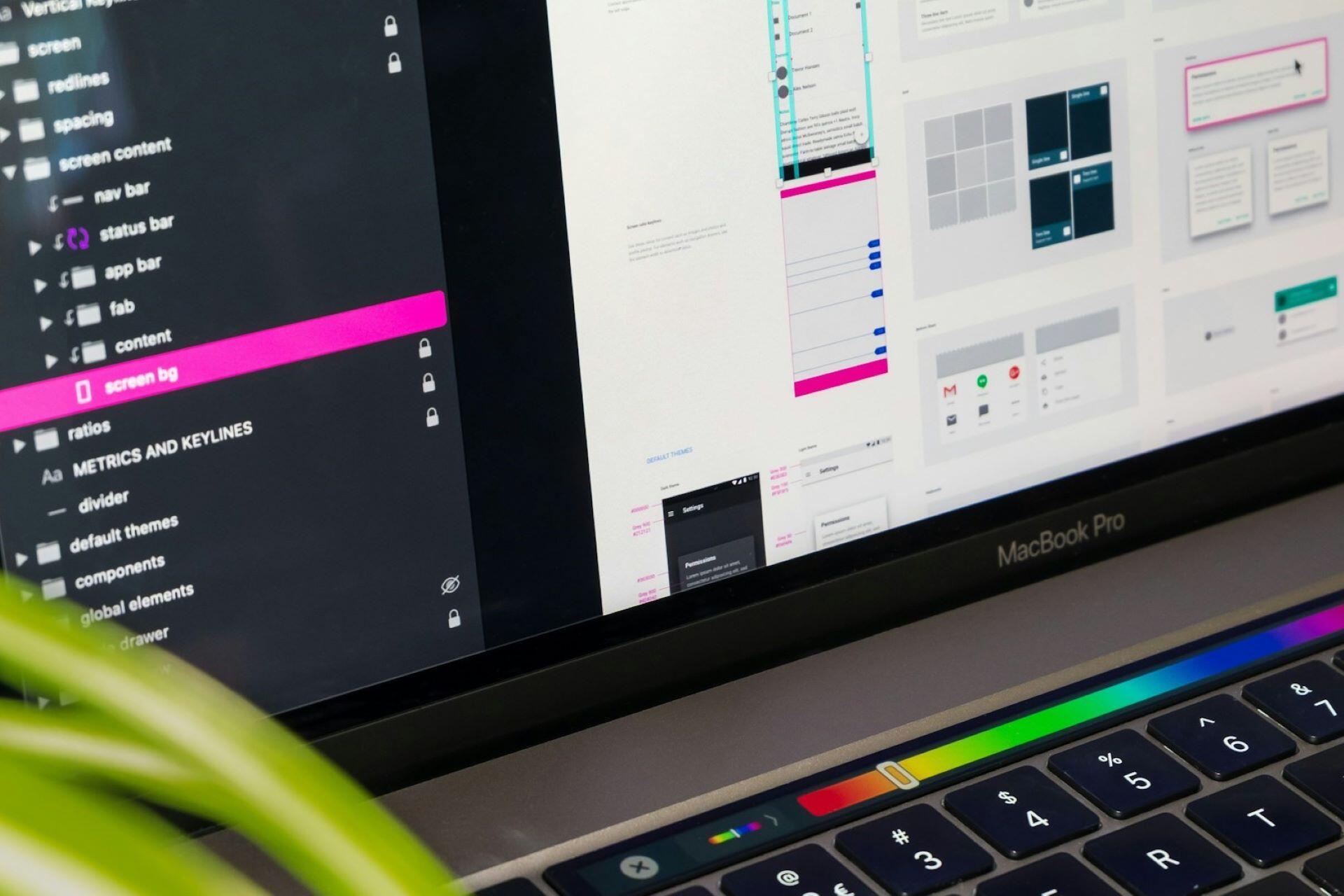 Close-up of a laptop showing digital layout and interface design work