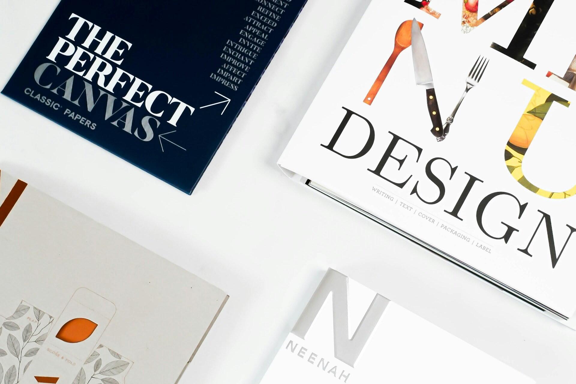 Design books and packaging layouts representing retail brand identity design
