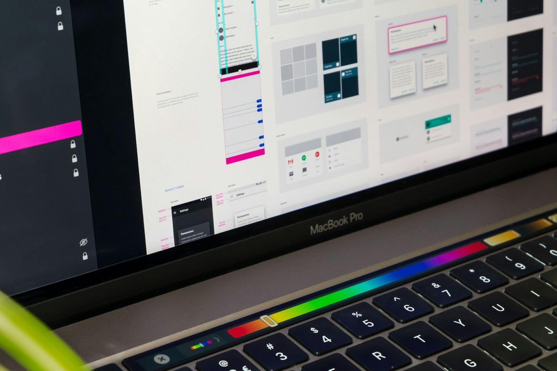 Laptop screen showing user interface design layouts for a digital product