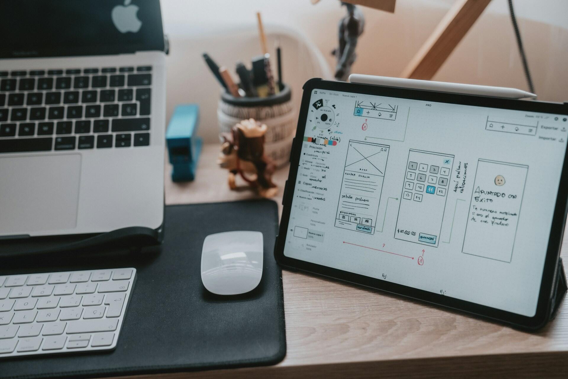 Tablet showing wireframe sketches on a designer’s desk