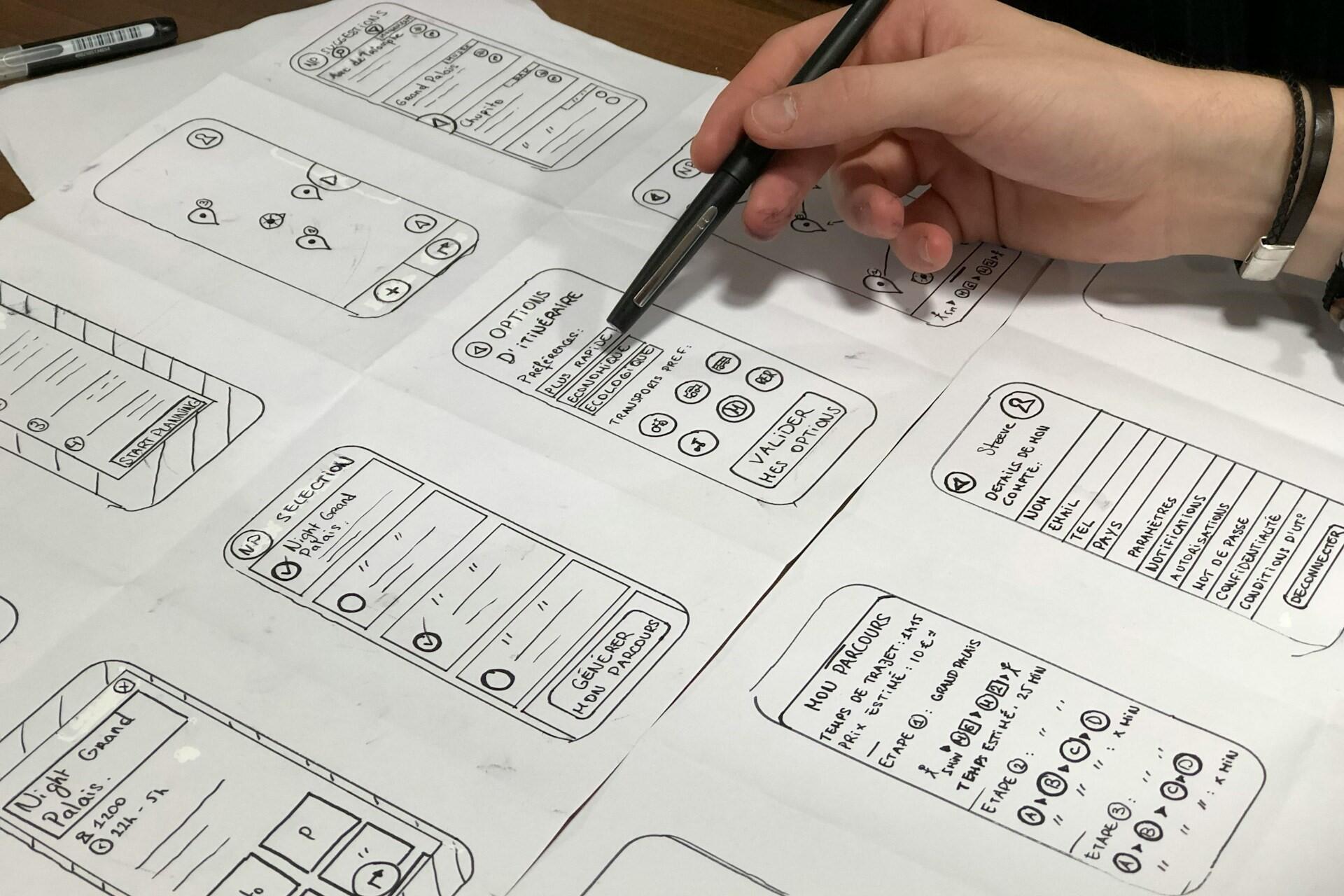 Hand drawing wireframe sketches for a mobile app interface