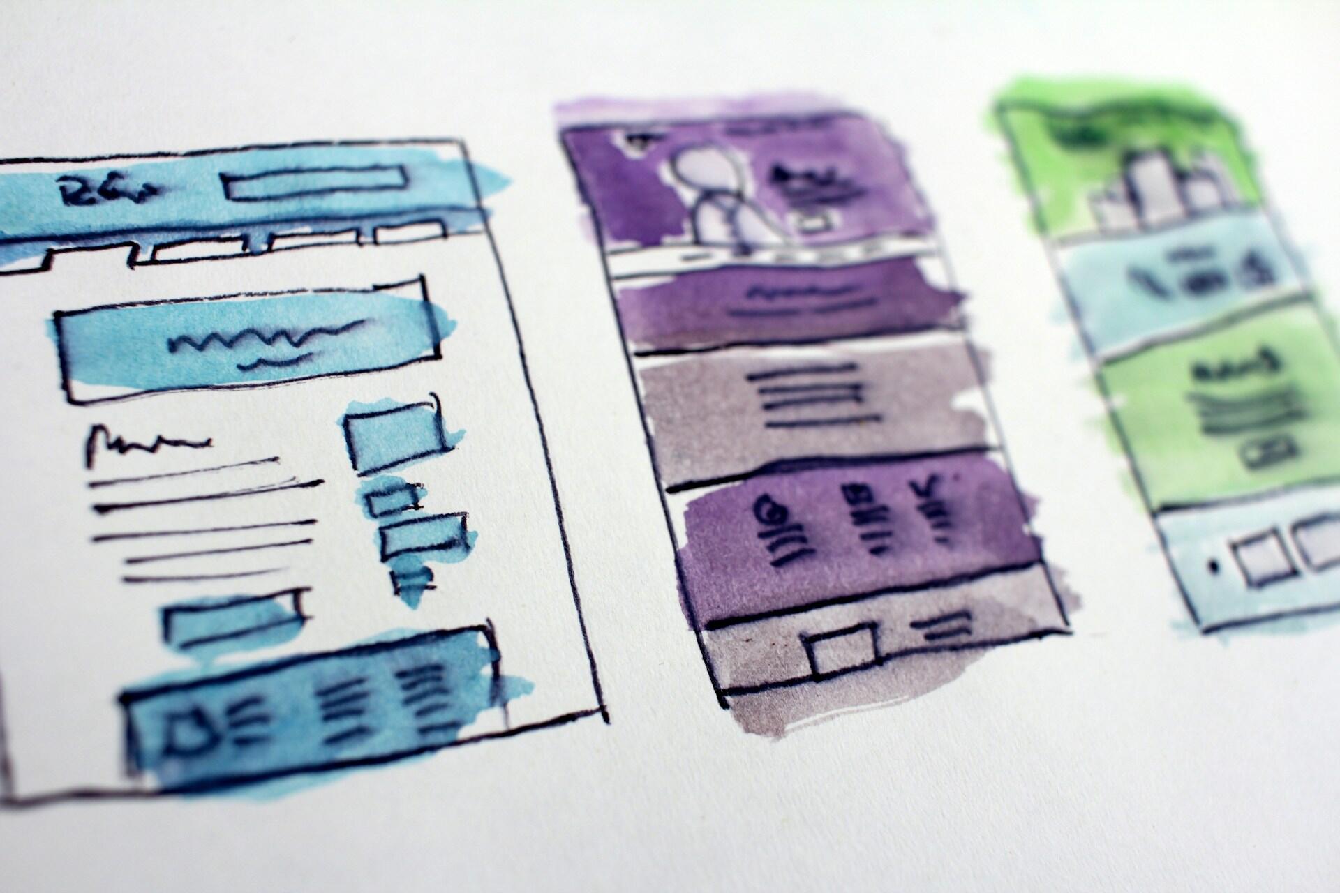 Colourful wireframe concepts sketched on paper