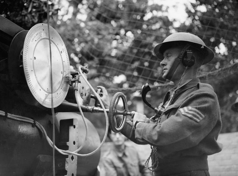 A soldier in army slacks and a helmet using anti invasion equipment, black and white
