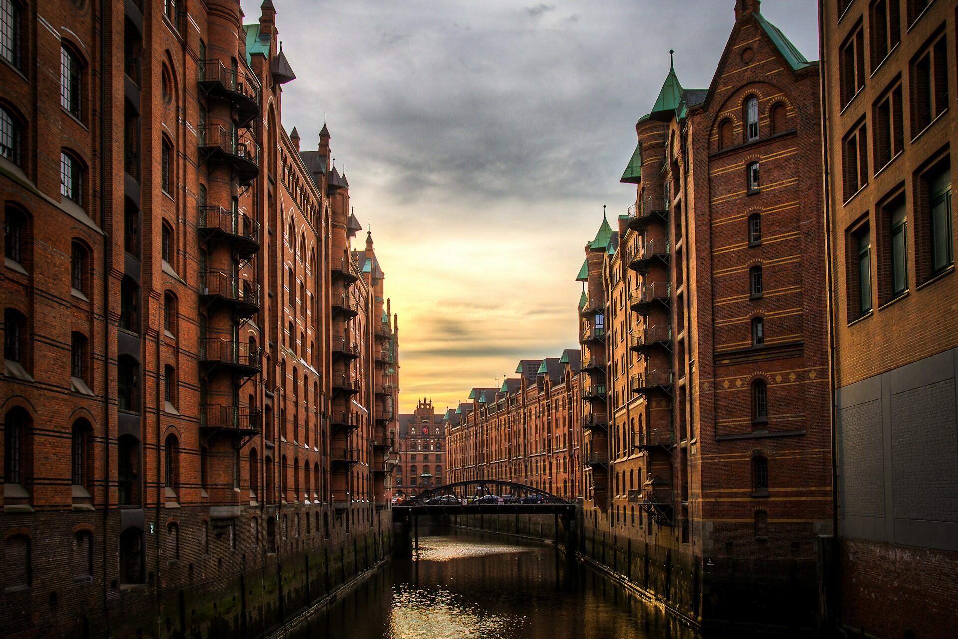 Brick warehouse buildings beside a canal at sunset