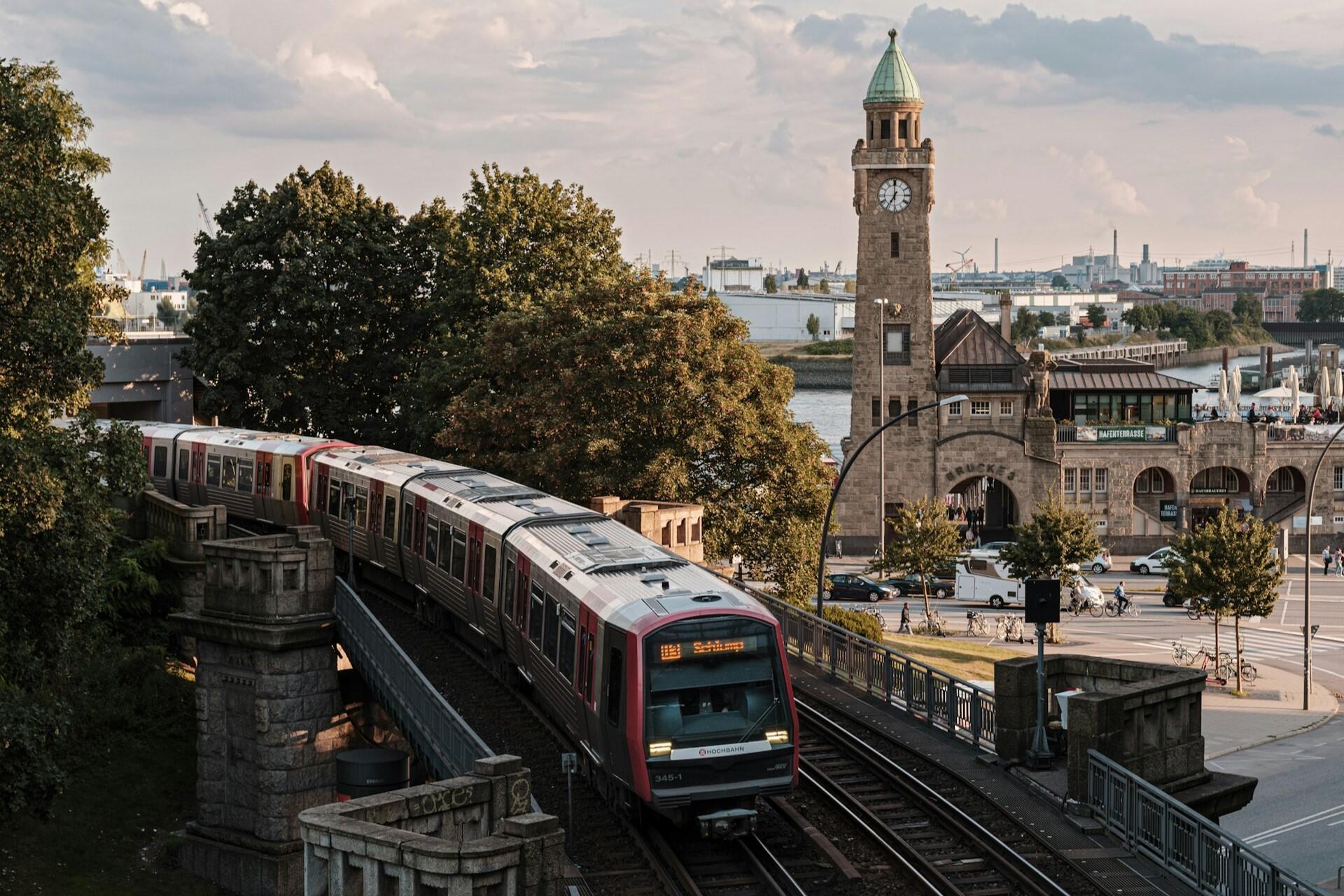 Train on elevated railway beside a clock tower