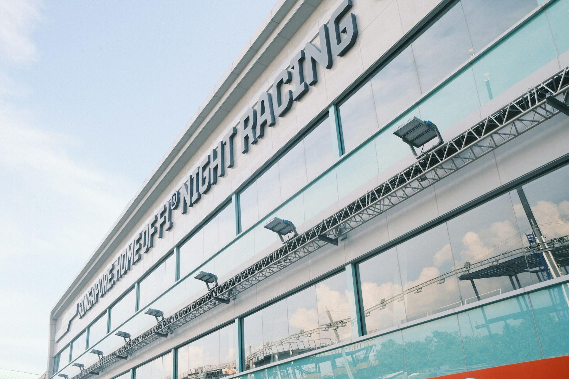 Exterior view of a modern building with large glass windows and the sign