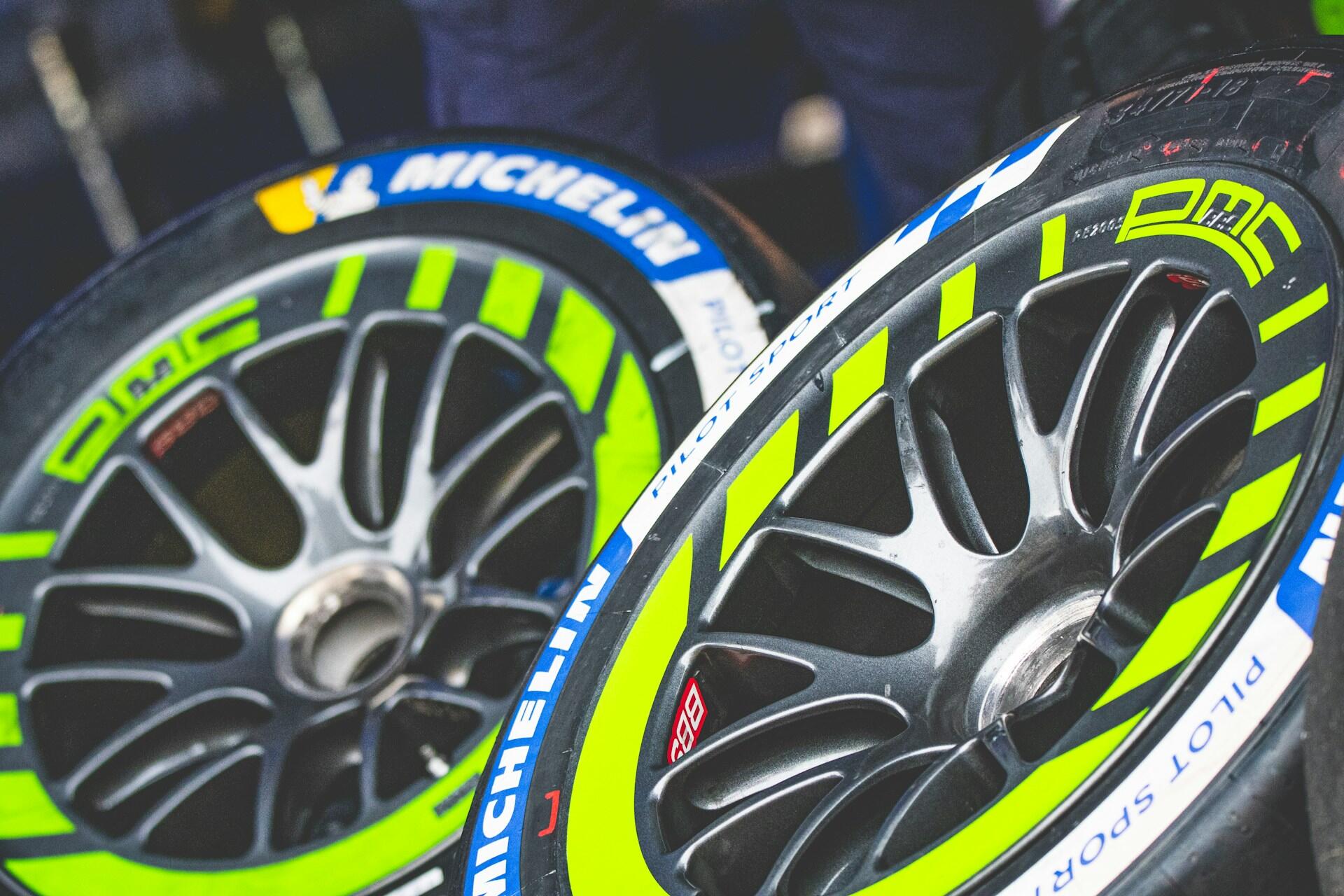 Car tires featuring vibrant green and yellow stripes, adding a unique and colorful design element to the vehicles.