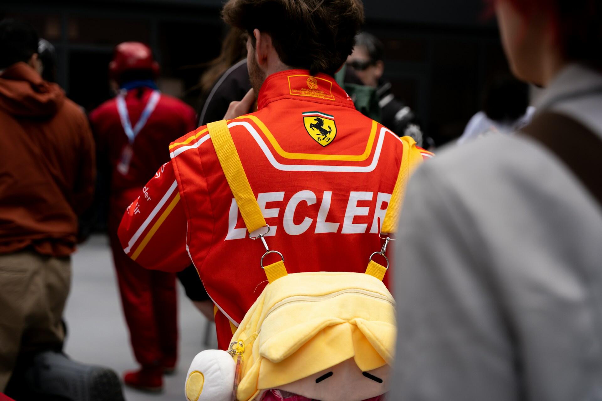 Person wearing a red Ferrari racing jacket with