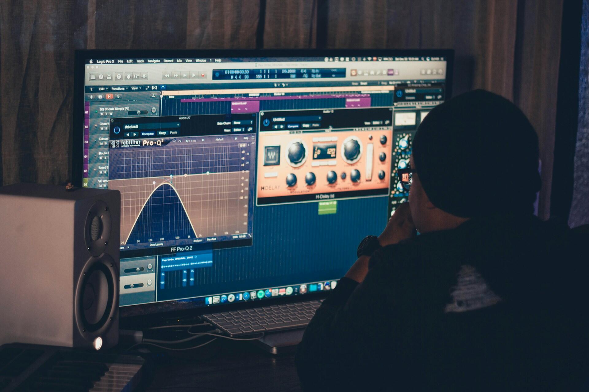 mastering engineer using plugins and DAW to edit music