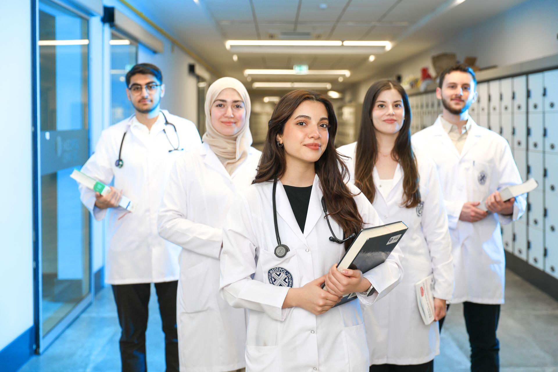 Medical staff made up of women and men stood in a hospital hall