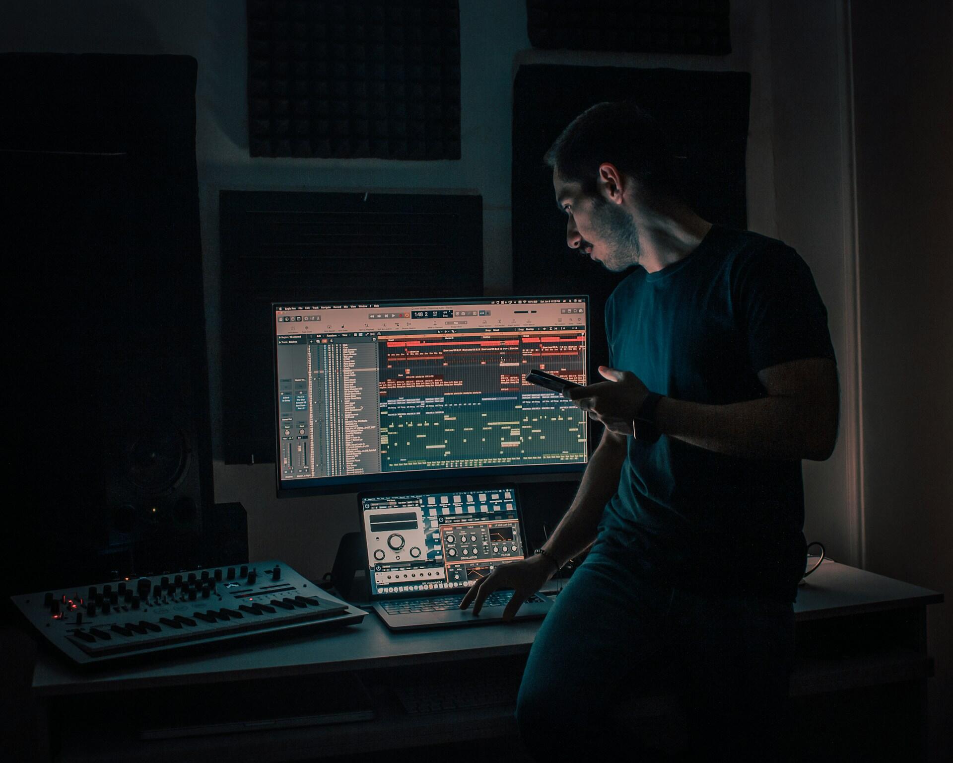 a mixing engineer editing tracks on a DAW on a large computer monitor