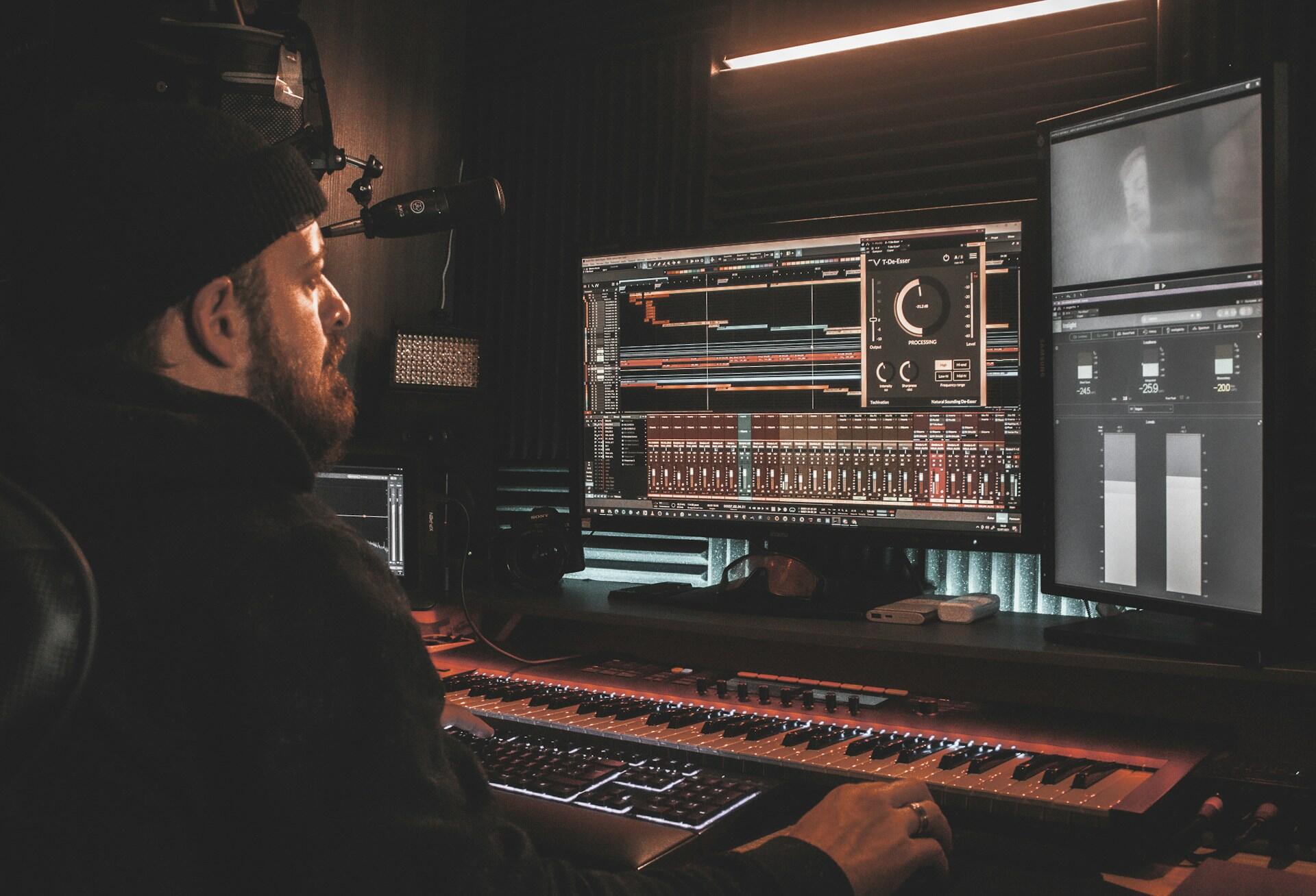 mixing and mastering engineer working on music with a DAW in a professional studio