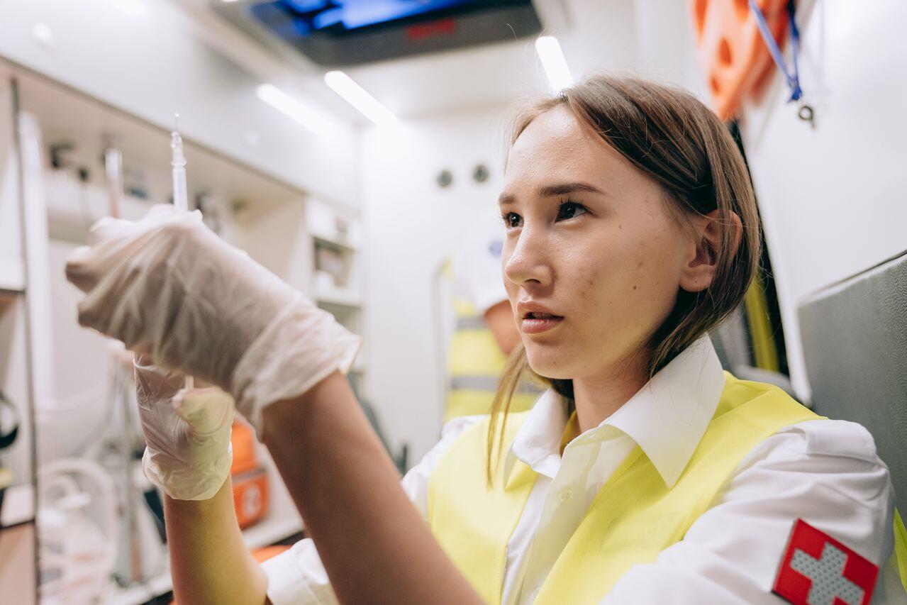 Lady in ambulance holding needle