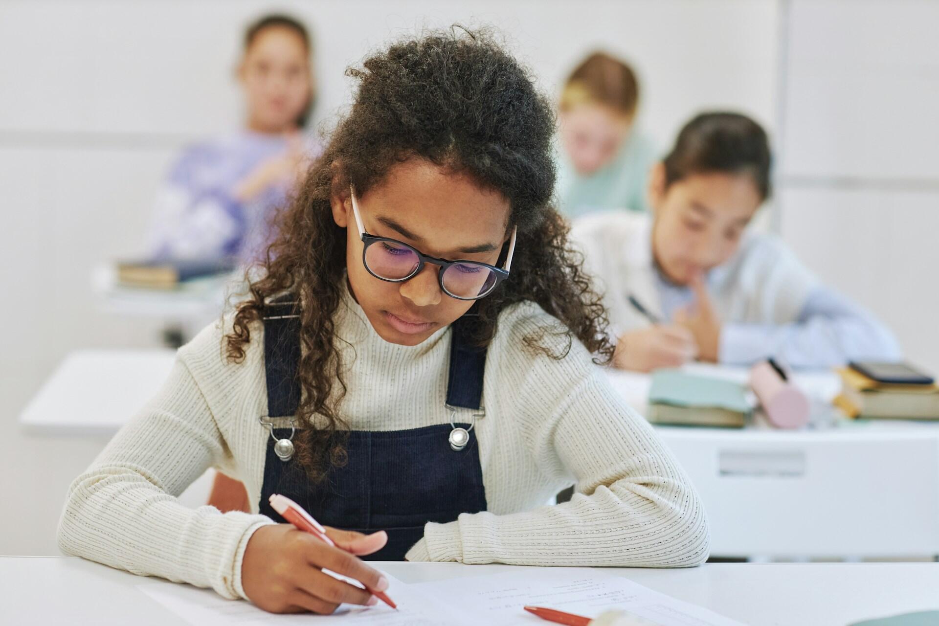 students in a classroom writing an exam