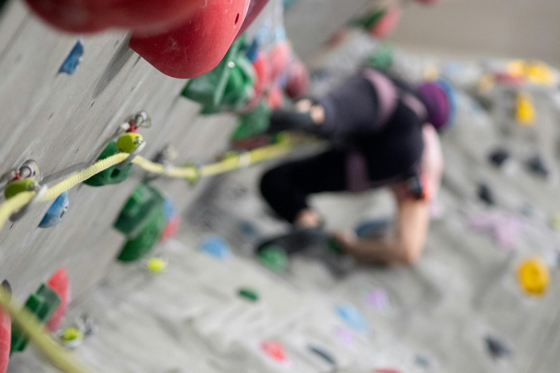 Climber tackling a steep artificial climbing wall