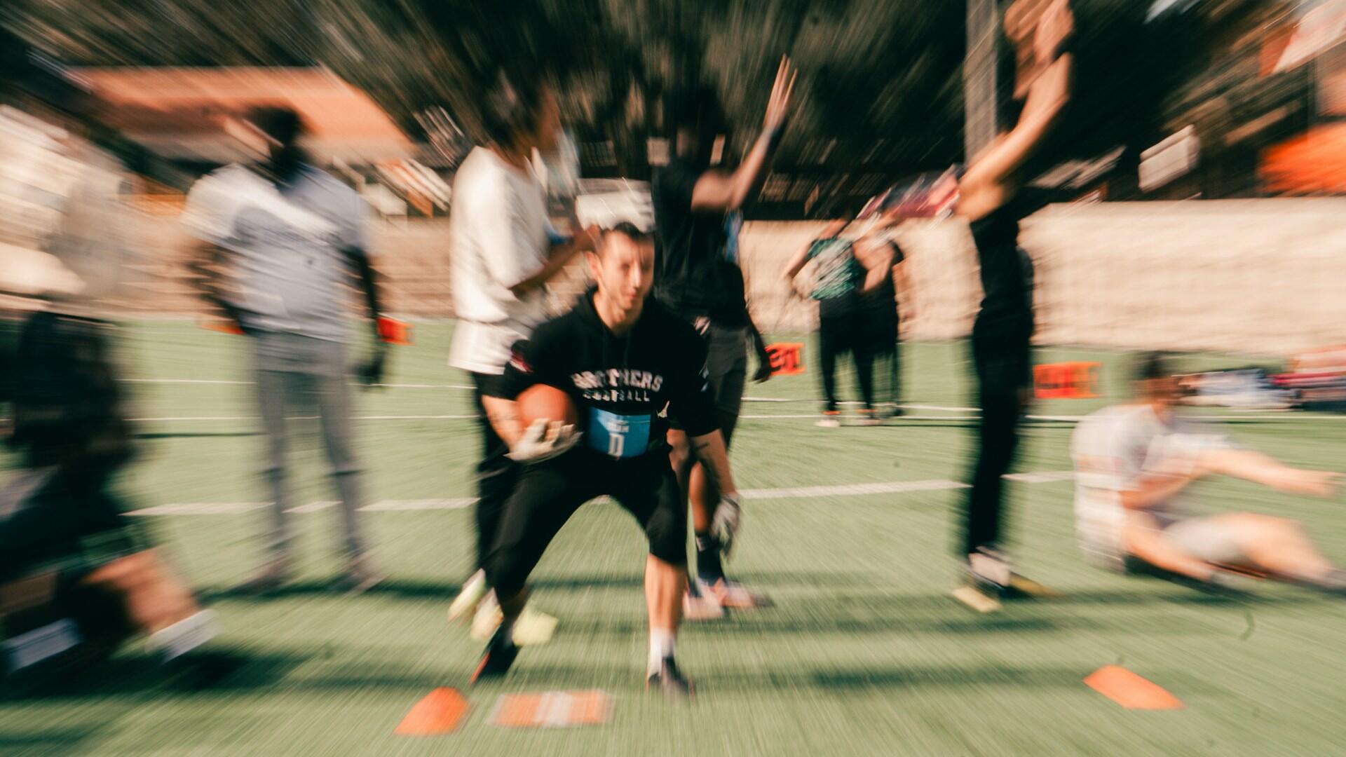Blurred photo of a flag football practice.