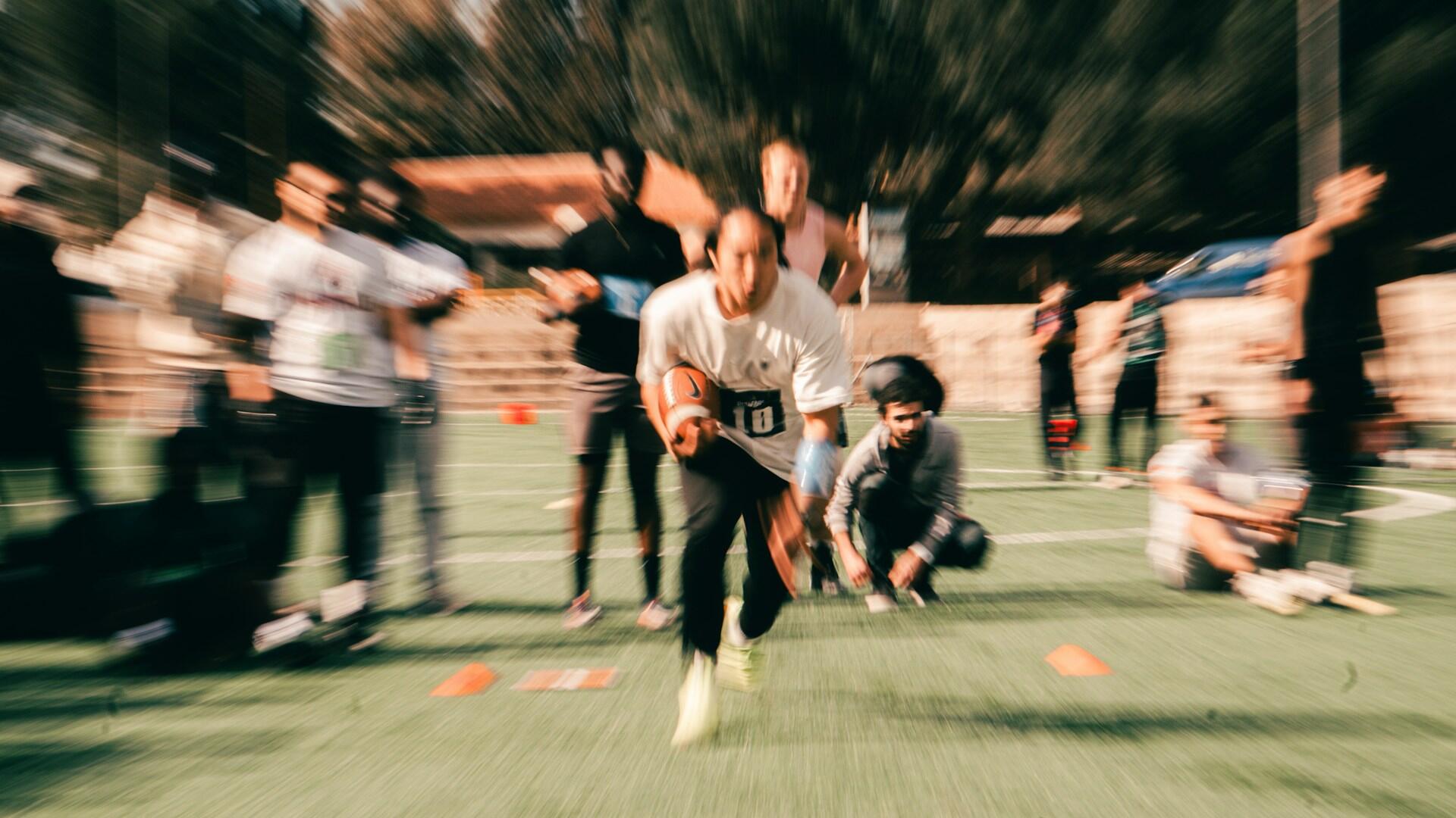 Blurry flag football defense practice.