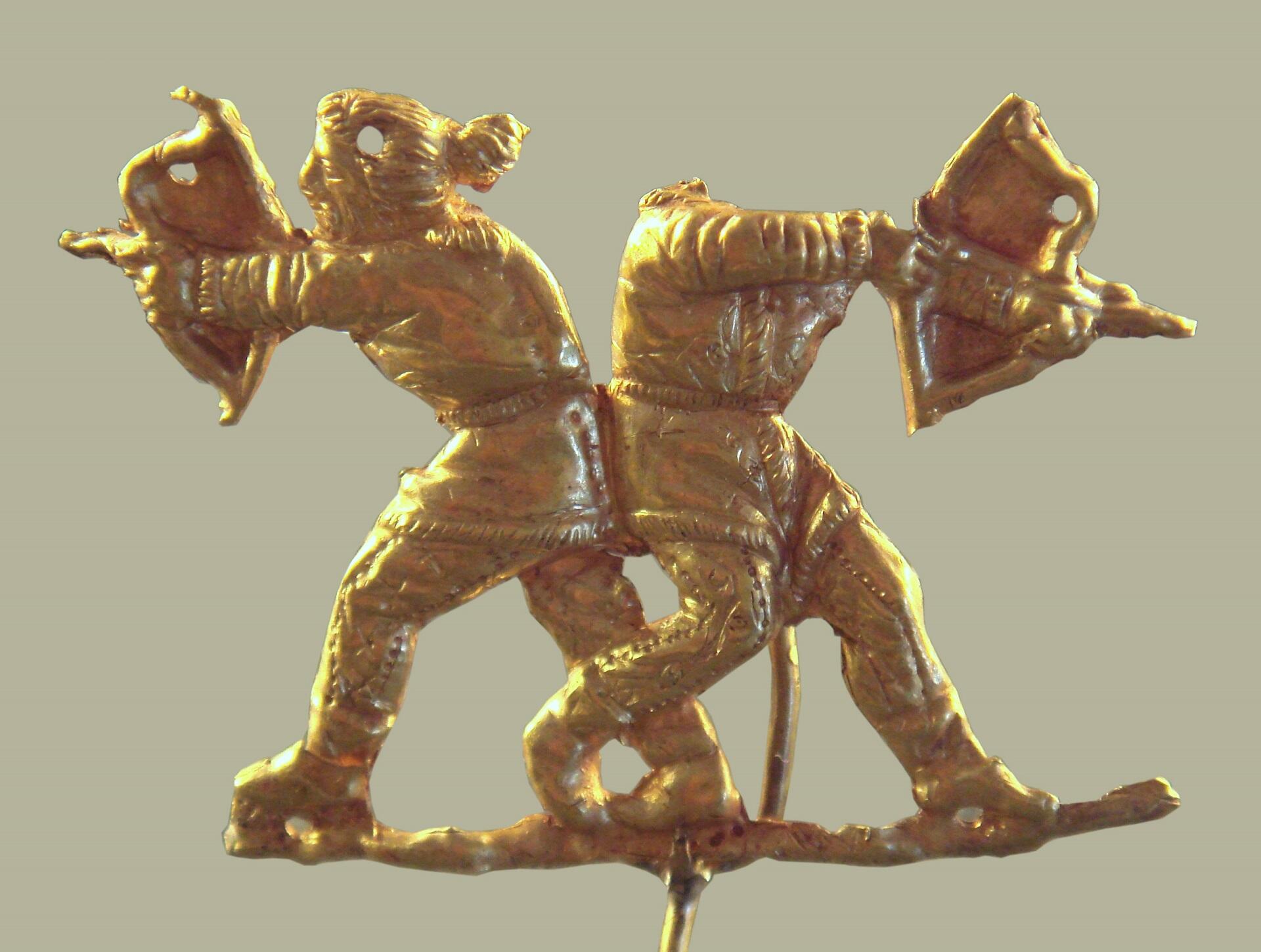 A bronze sculpture of two archers holding their weapons aloft, preparing to fire. They are shown wearing belted garments similar to the Korean hanbok.
