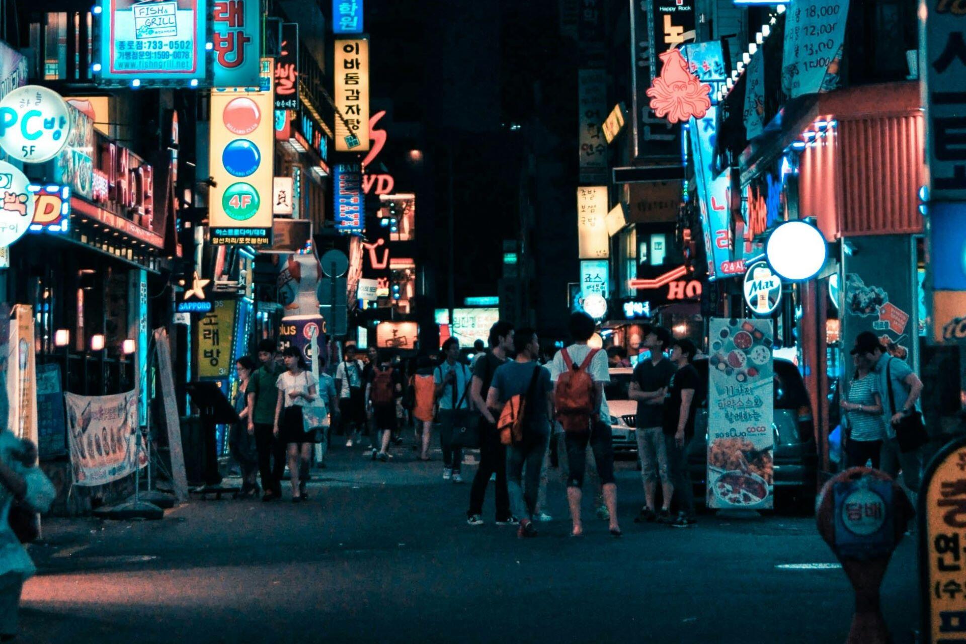 Busy neon-lit street in Seoul at night