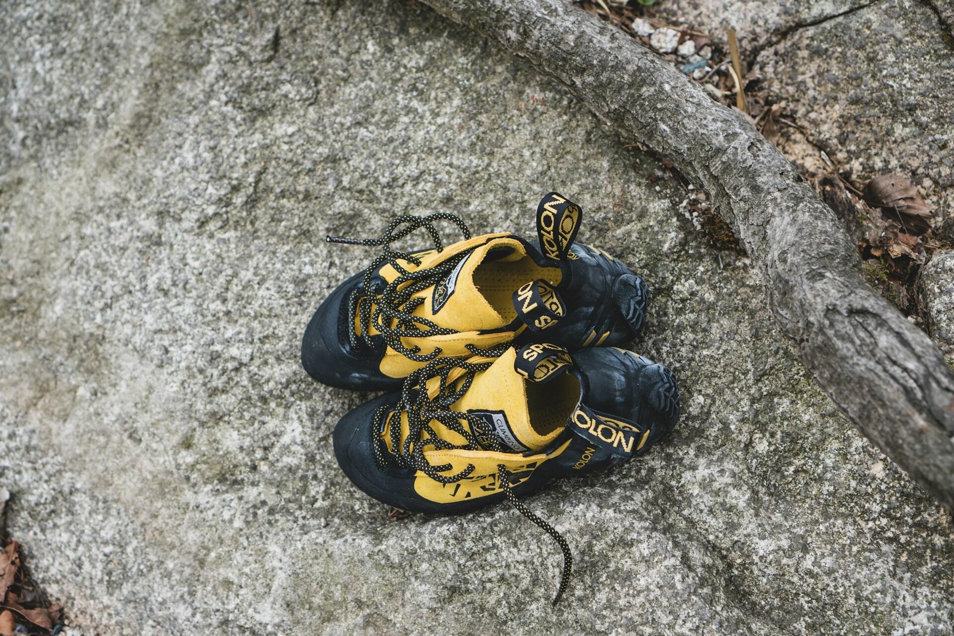 Yellow climbing shoes resting on outdoor rock