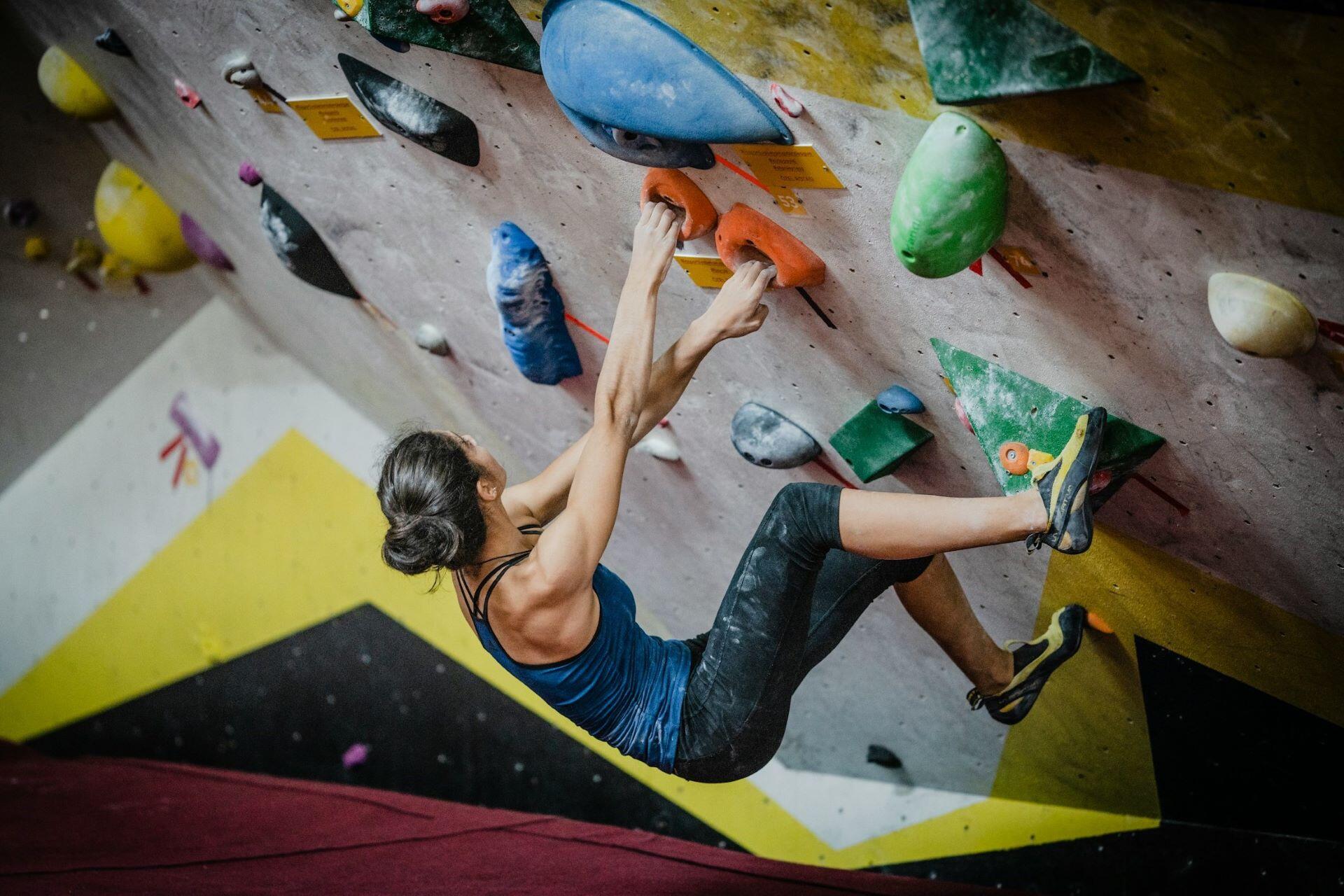 Woman climbing on an indoor bouldering wall