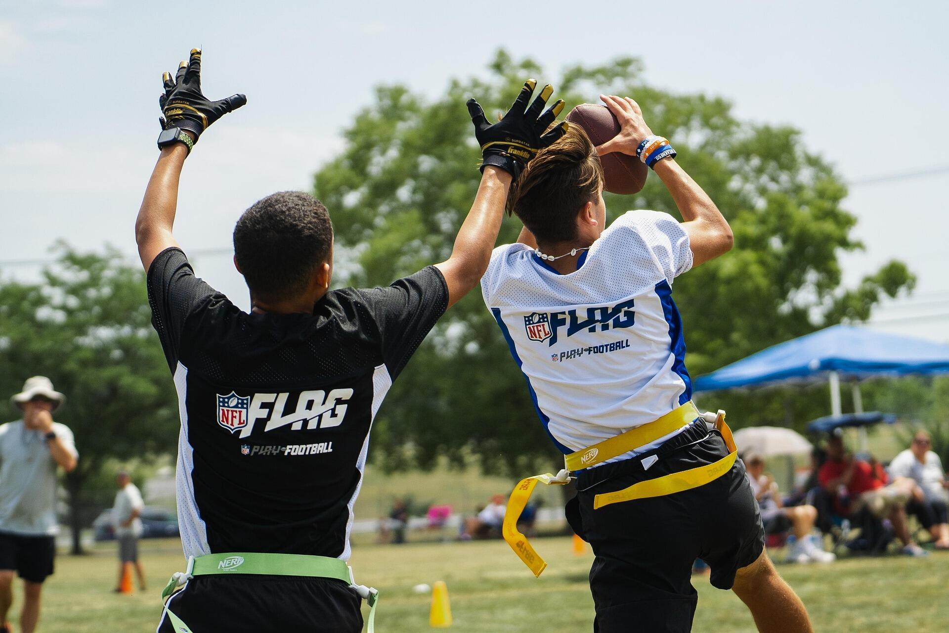 Youth players competing in flag football.