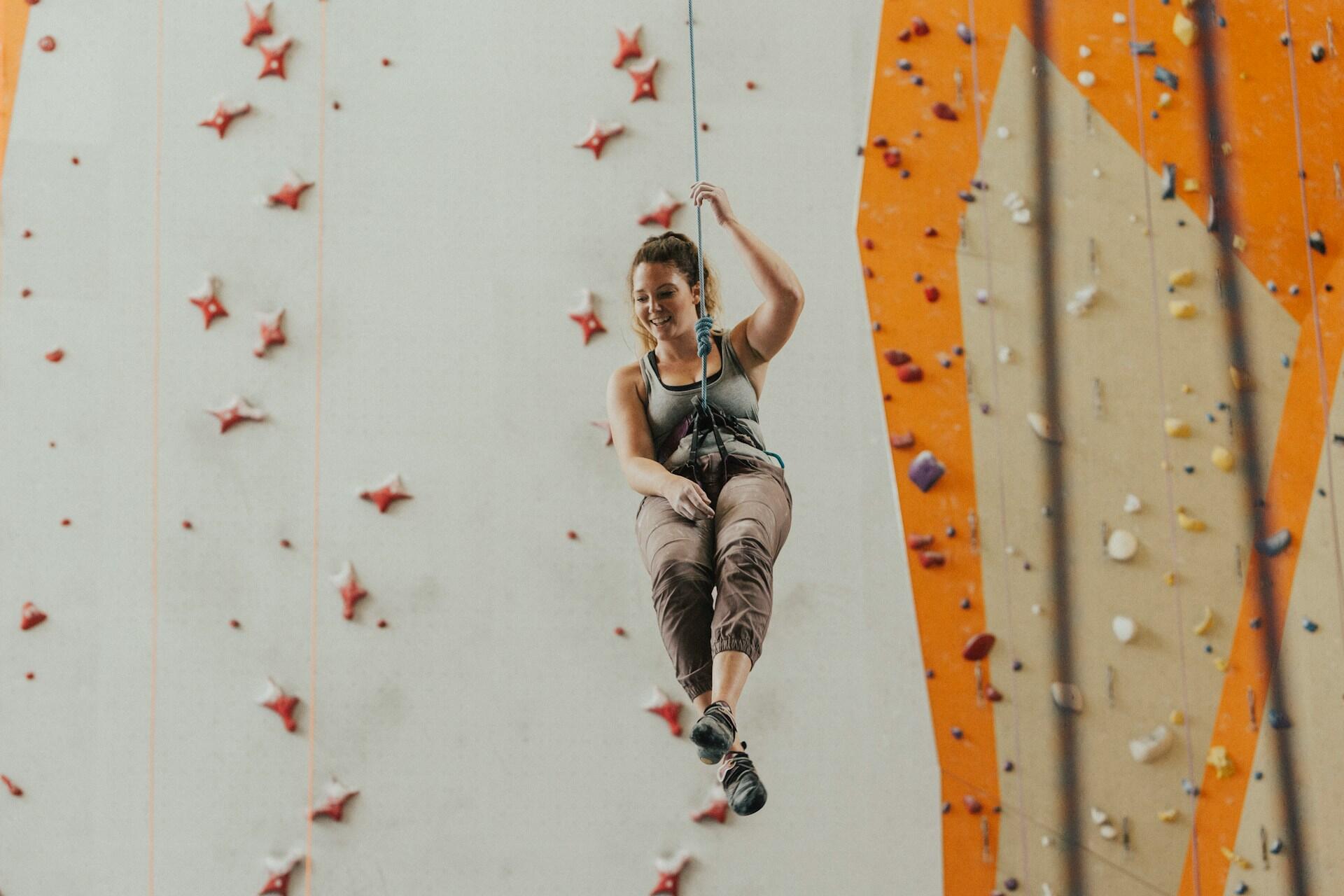 Climber wearing a harness on an indoor roped climbing wall